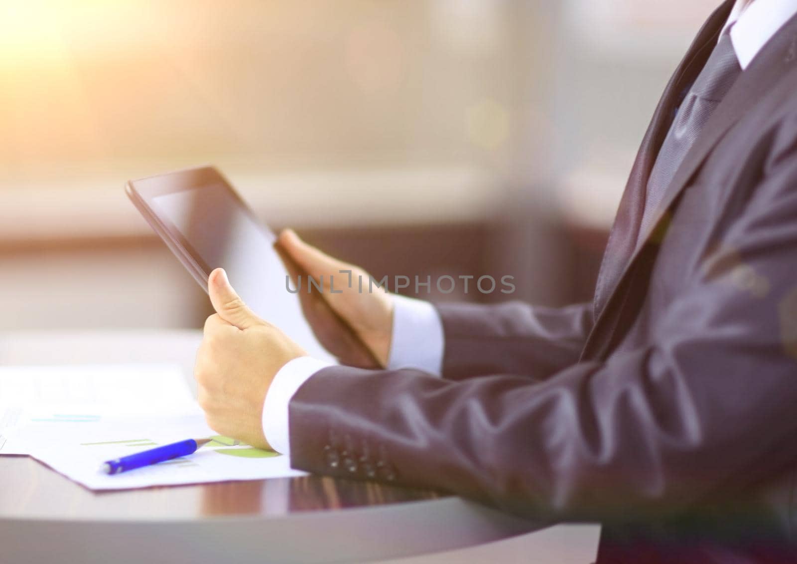 close up. businessman with digital tablet at the Desk. by SmartPhotoLab
