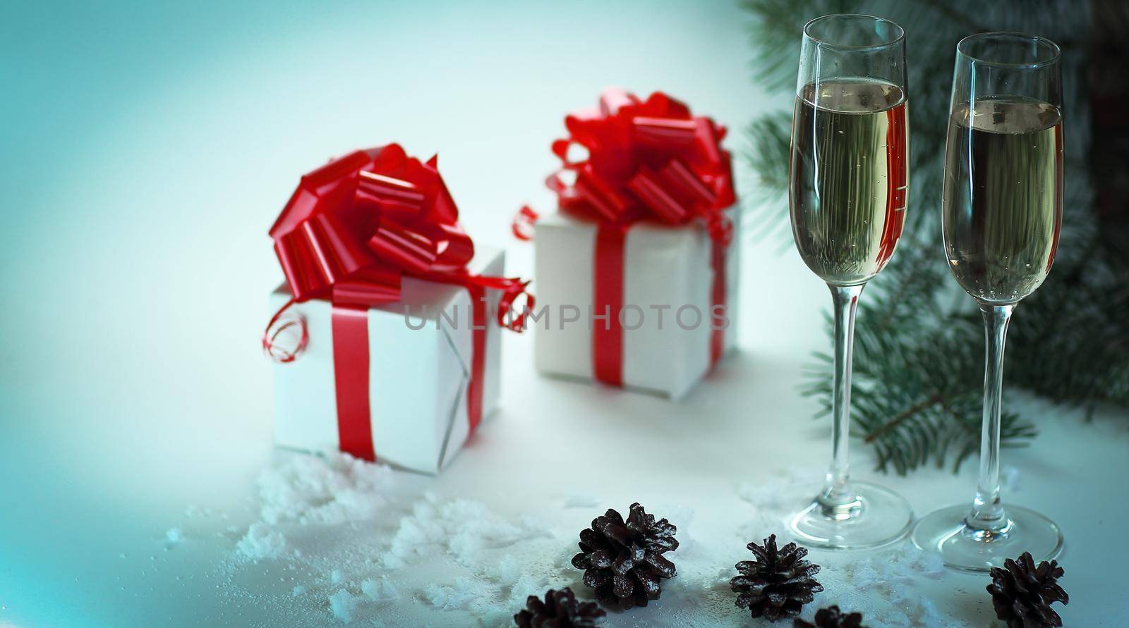 two glasses with champagne and Christmas gifts at the Christmas background .photo with copy space.