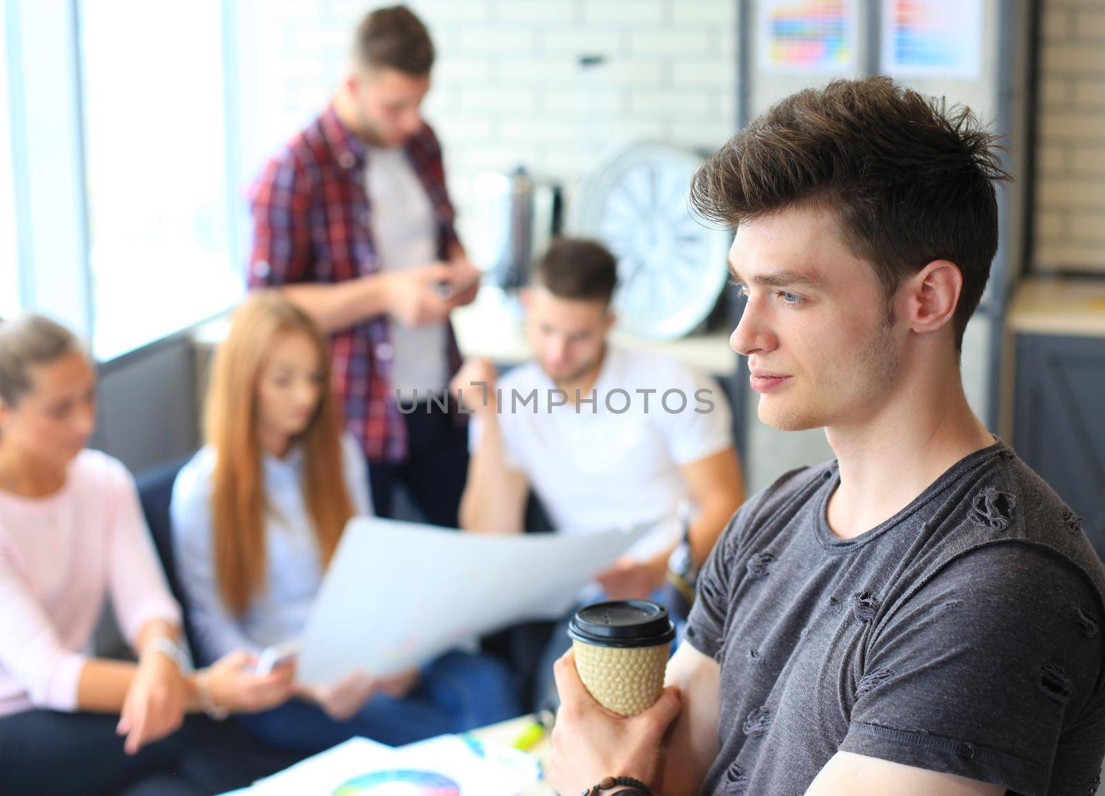 Businessman with colleagues in the background in office by tsyhun