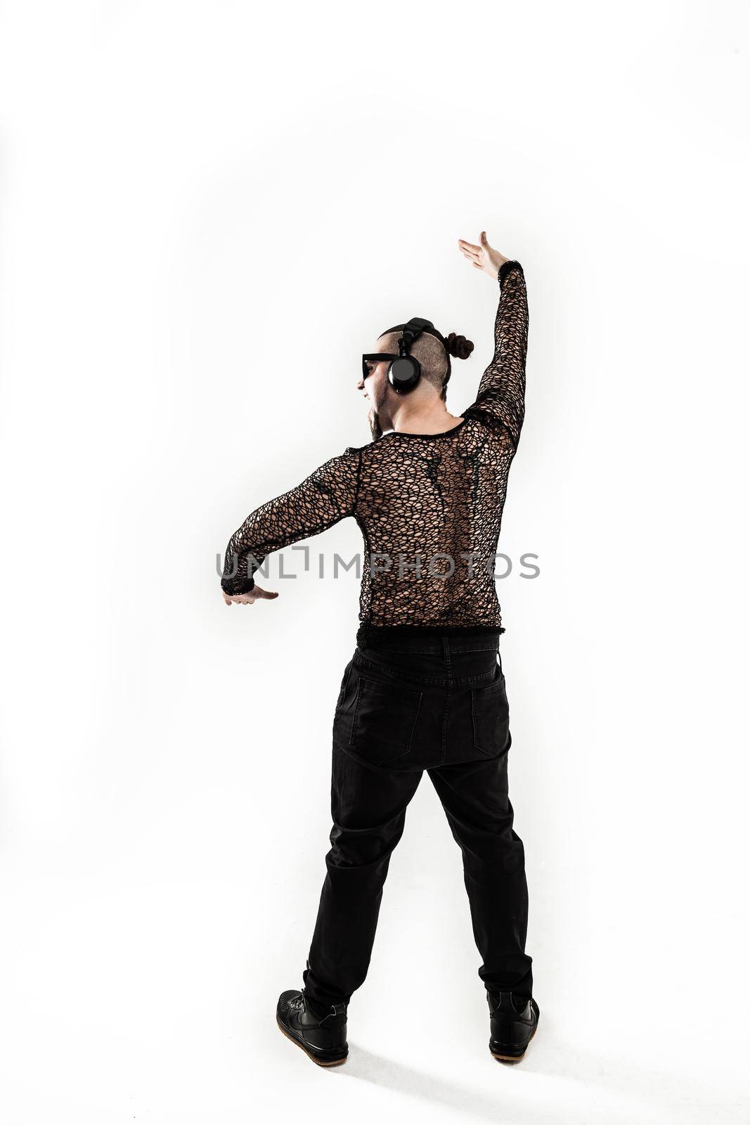 creative rapper in the headphones and dark glasses performs a rap song .photo on a white background and has an empty space for your text