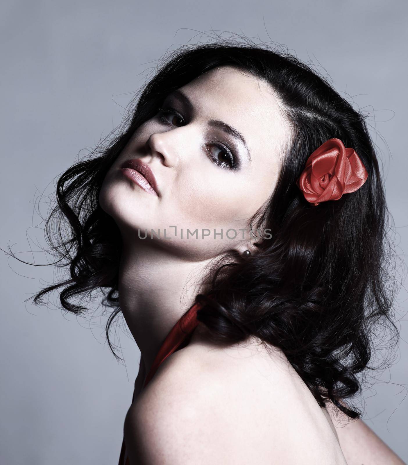 portrait of a modern stylish woman in a red evening dress.isolated on gray background.