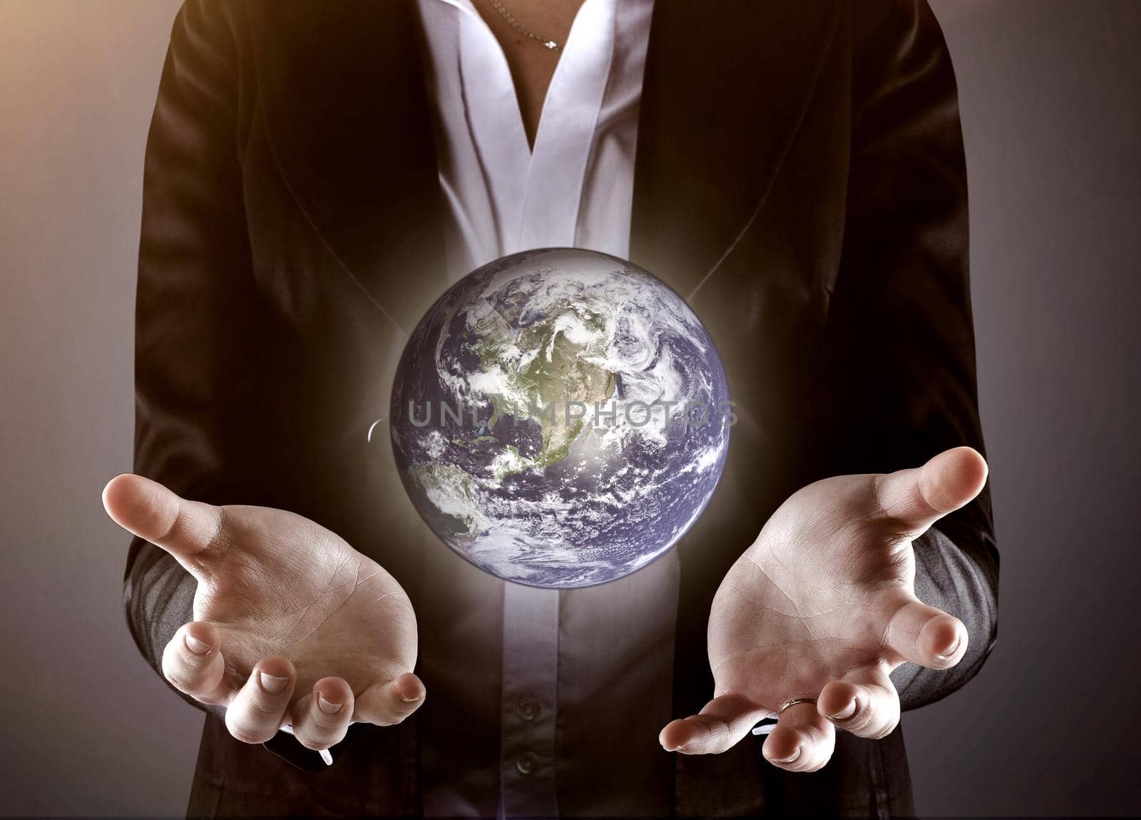 close up.businessman holding the globe.photo on a gray background by SmartPhotoLab