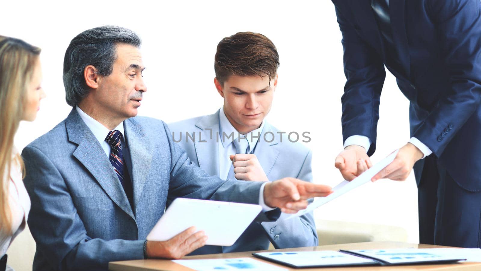 Business team interviewing young applicant in bright office
