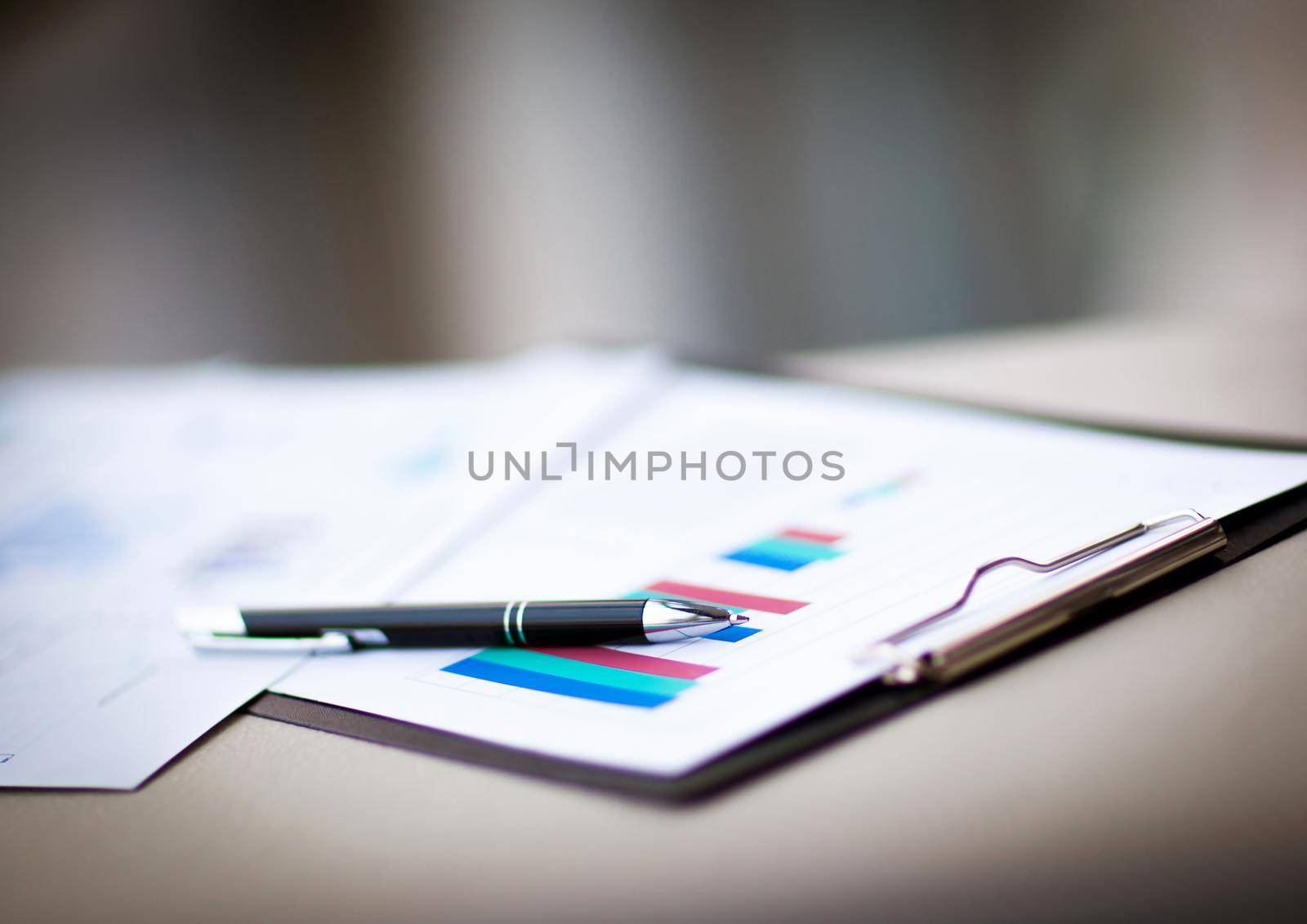 financial charts and graphs in the table. Workplace in office