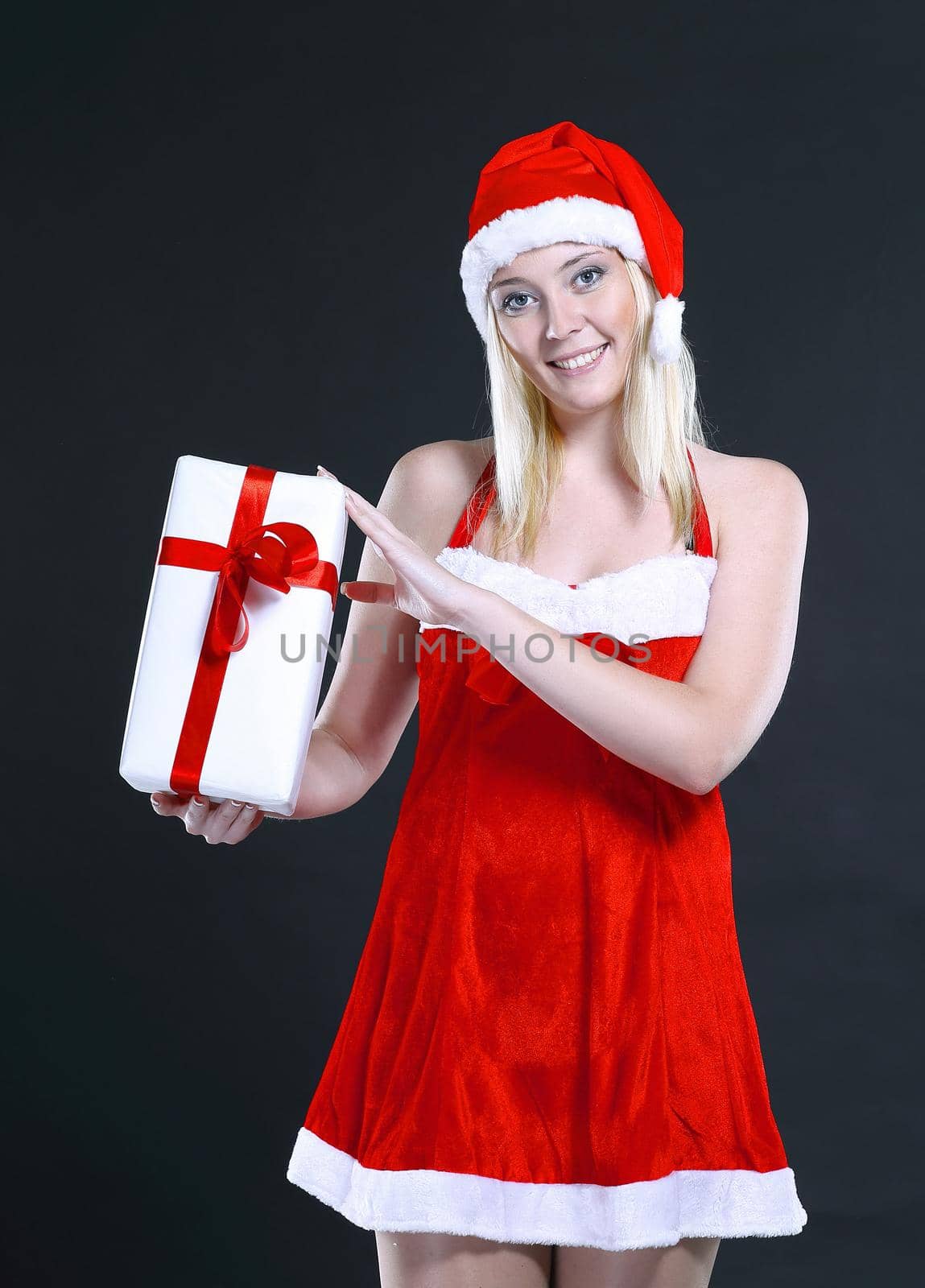 blonde woman in costume of Santa Claus with Christmas gift.photo with copy space.