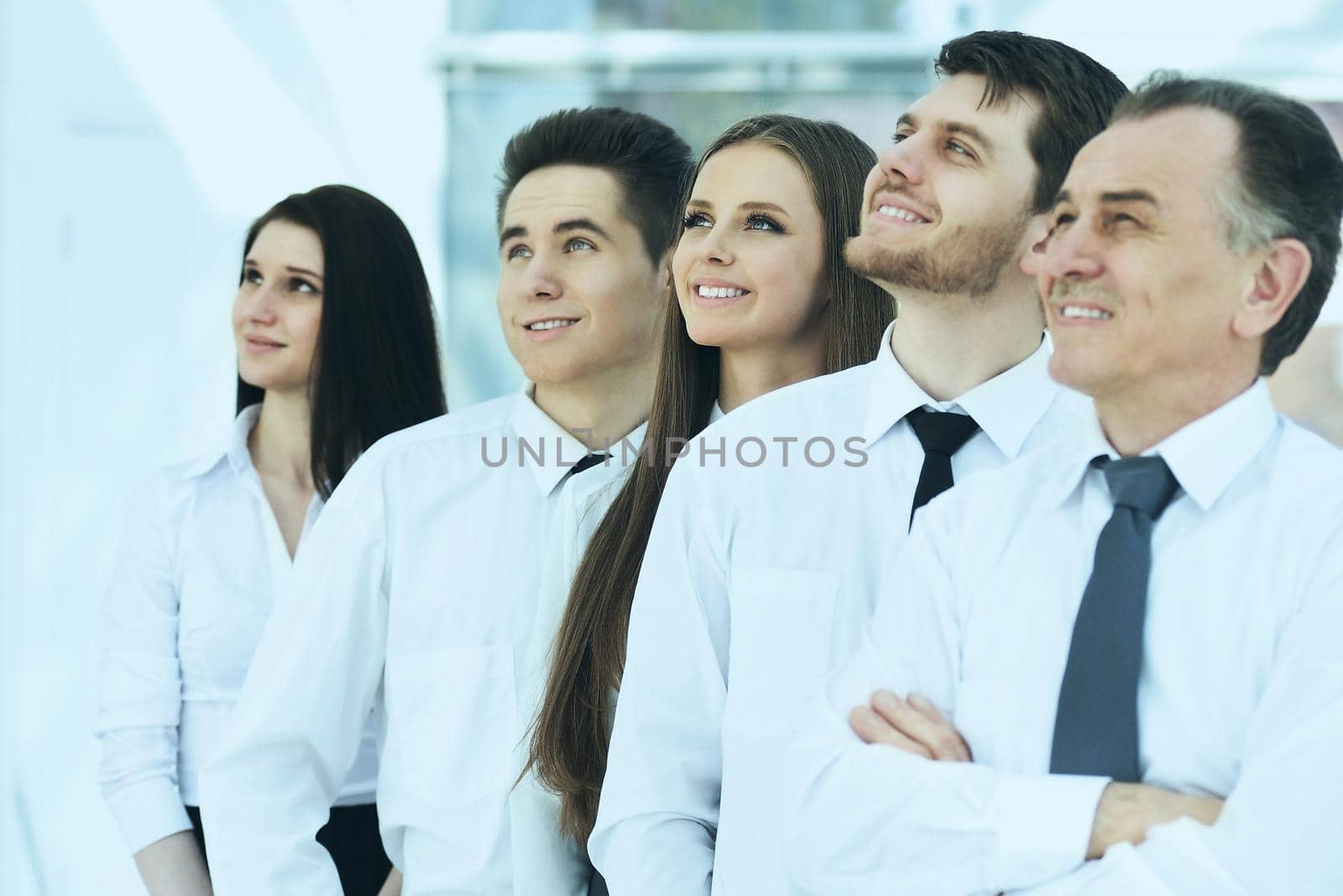 Group of friendly businesspeople with happy female leader in front