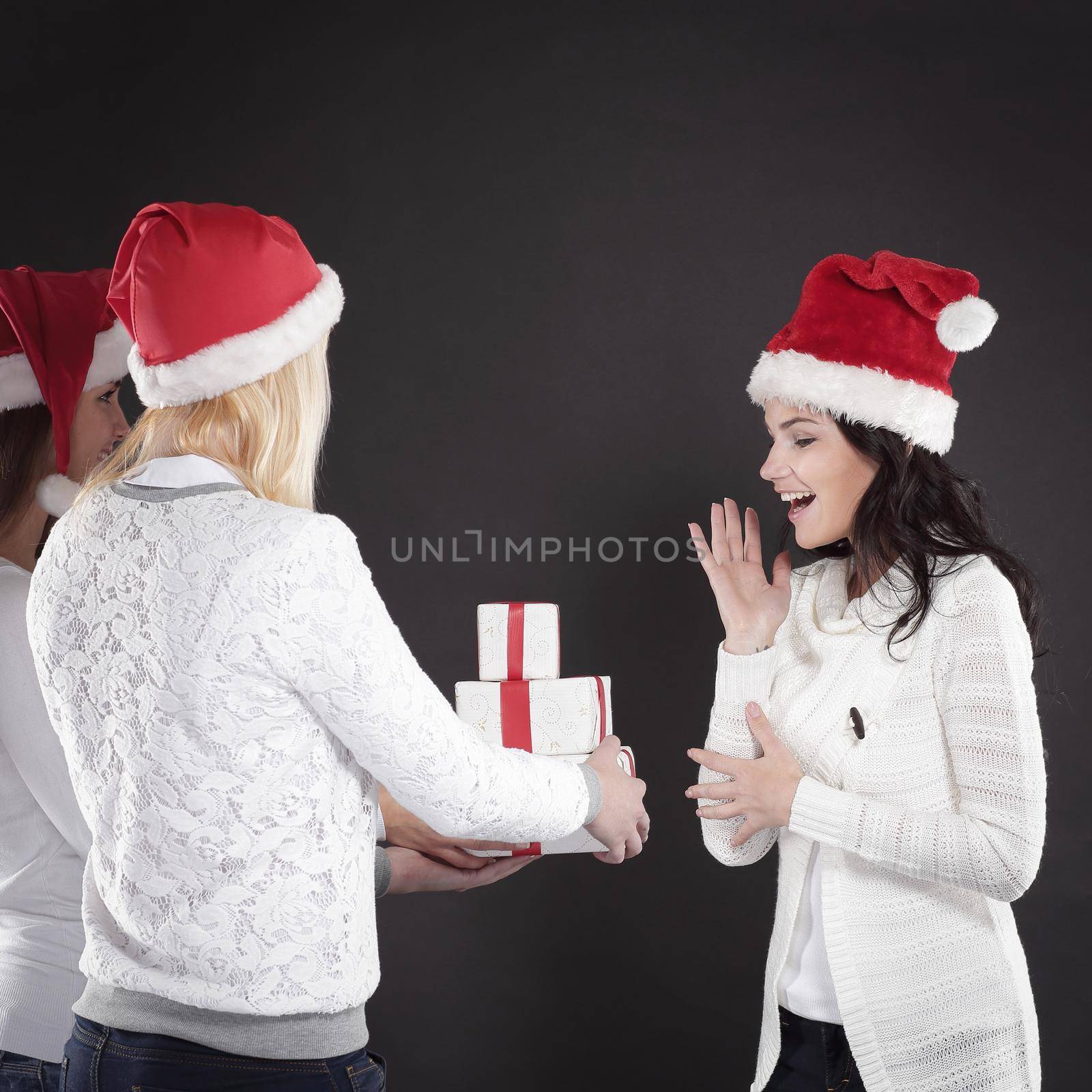 three happy young girl in costume of Santa Claus with Christmas by SmartPhotoLab