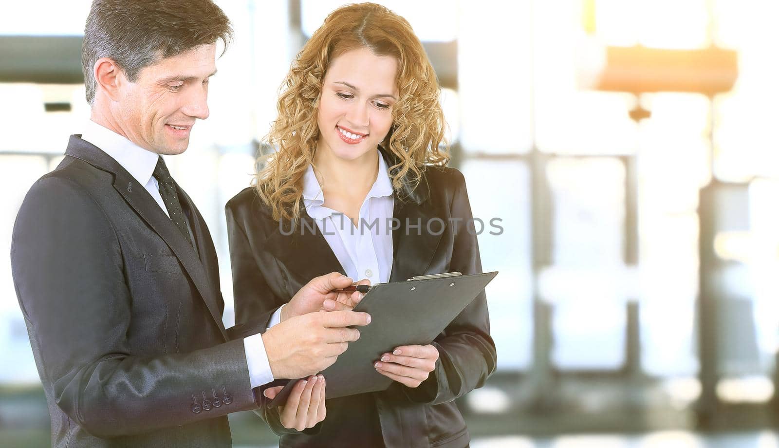 close up.company employees discussing business document by SmartPhotoLab