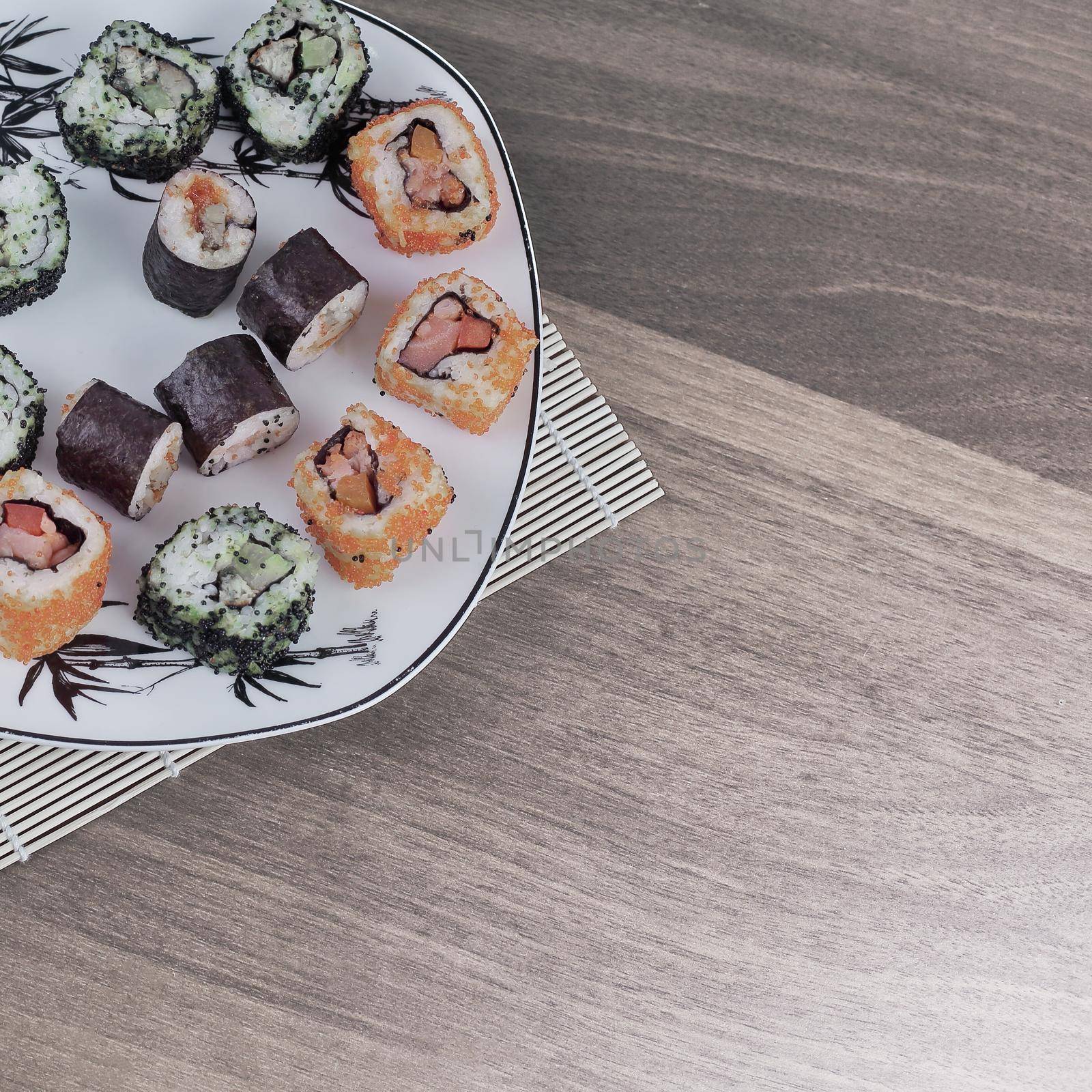 close-up of sushi and chopsticks on a white plate by SmartPhotoLab