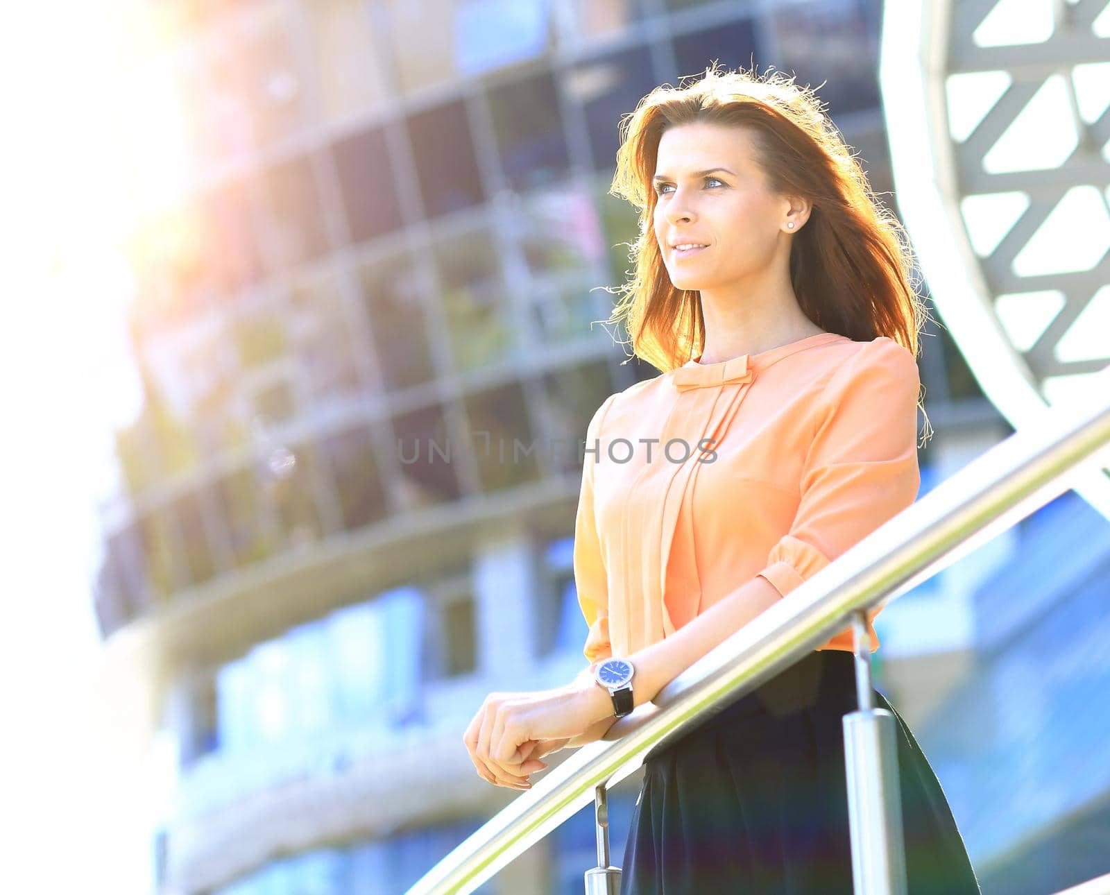 successful business woman on the background of office building by SmartPhotoLab