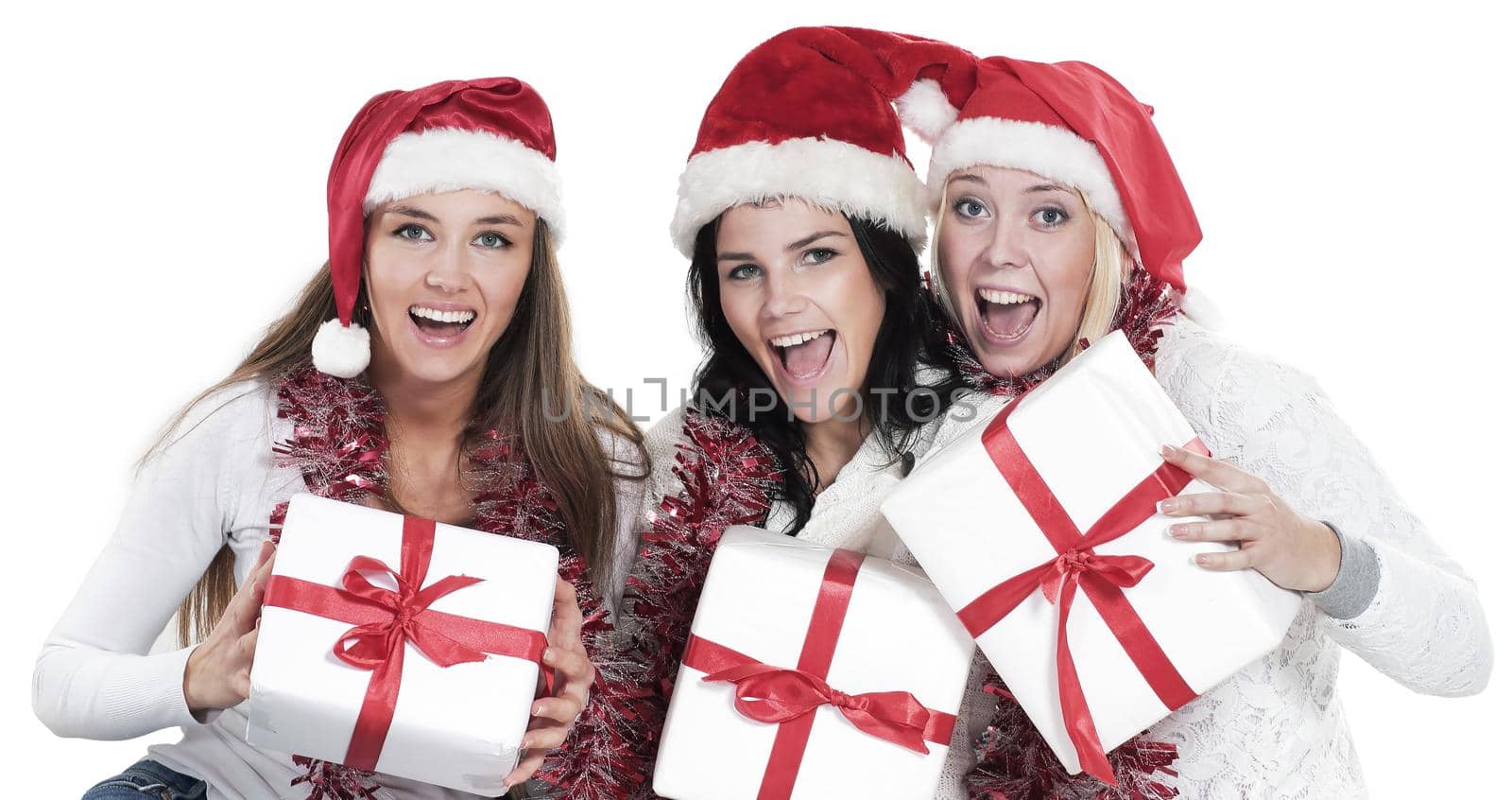 closeup.three young women in hats of Santa Claus with Christmas gifts. the concept of Christmas.