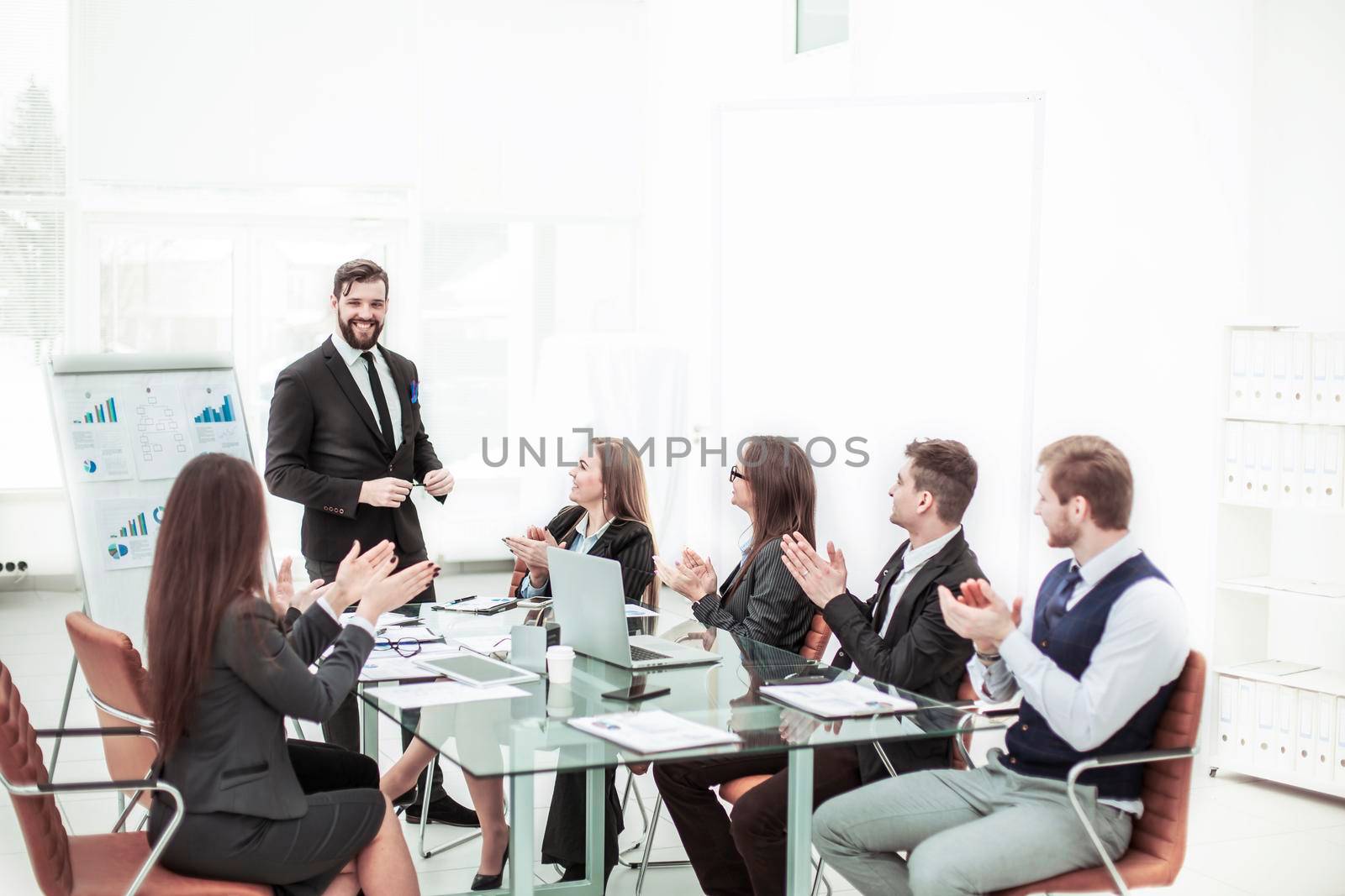 successful business team applauding the Manager Finance on the presentation of the new project in the workplace in the office