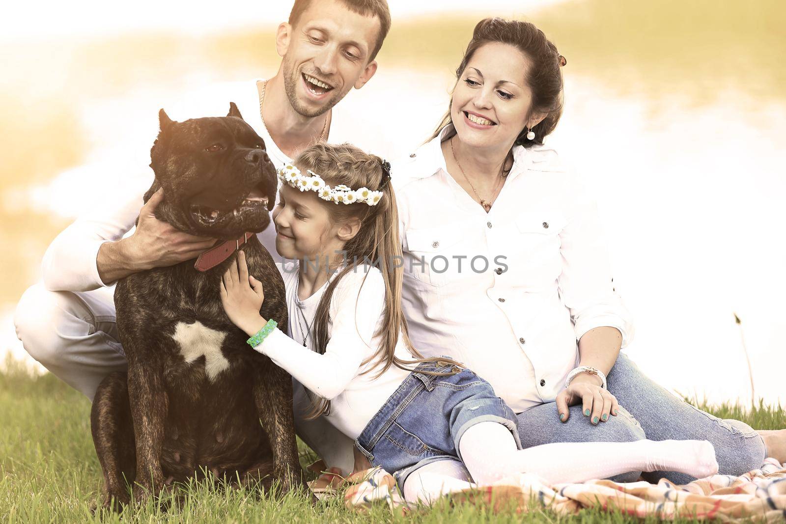 happy family with pet dog at picnic in a Sunny summer day. pregn by SmartPhotoLab