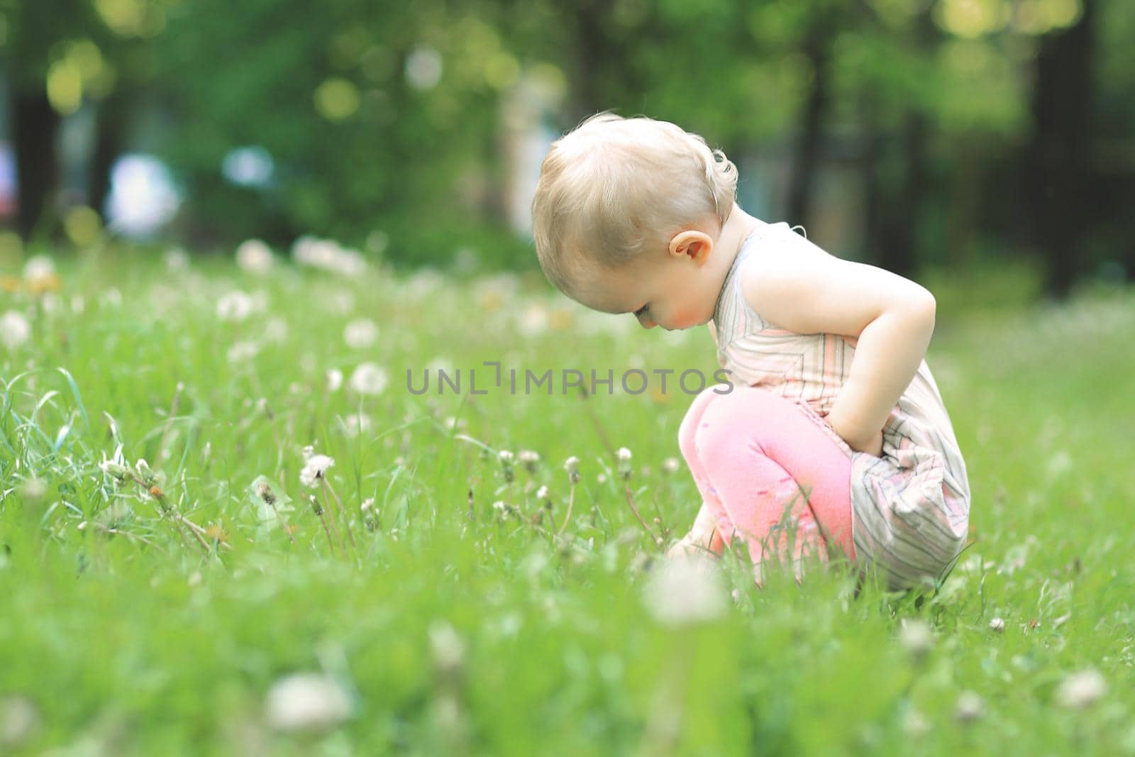 Little cute girl walking in a summer Park