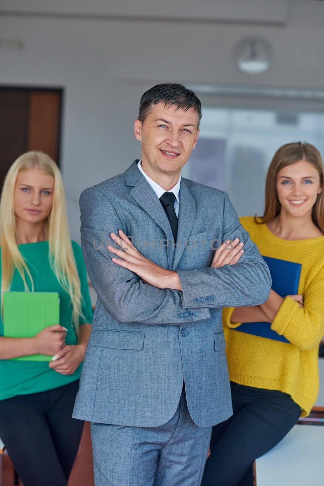 group portrait of teacher with students in shcool classrom