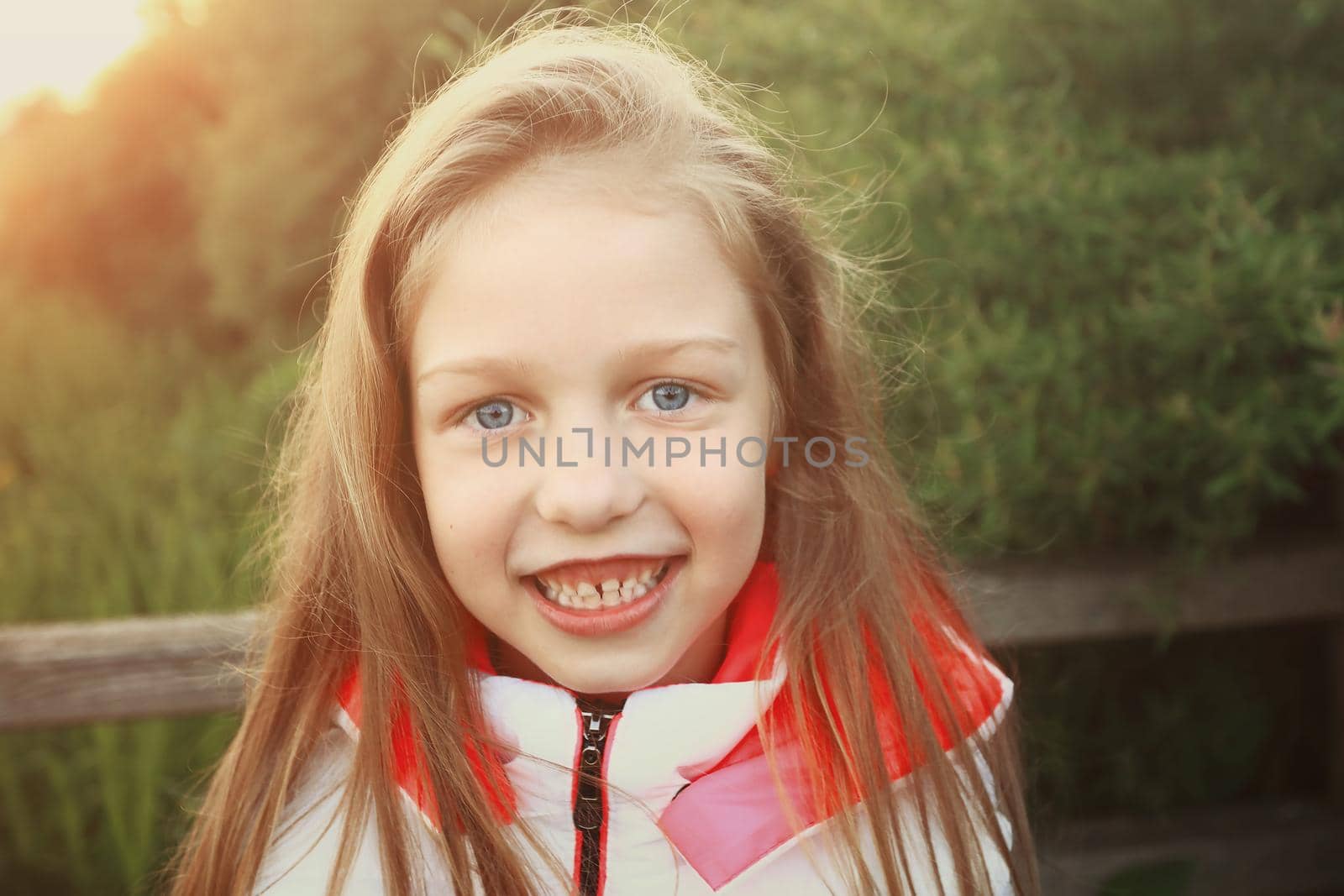 portrait of a little girl on the background of the Park. by SmartPhotoLab