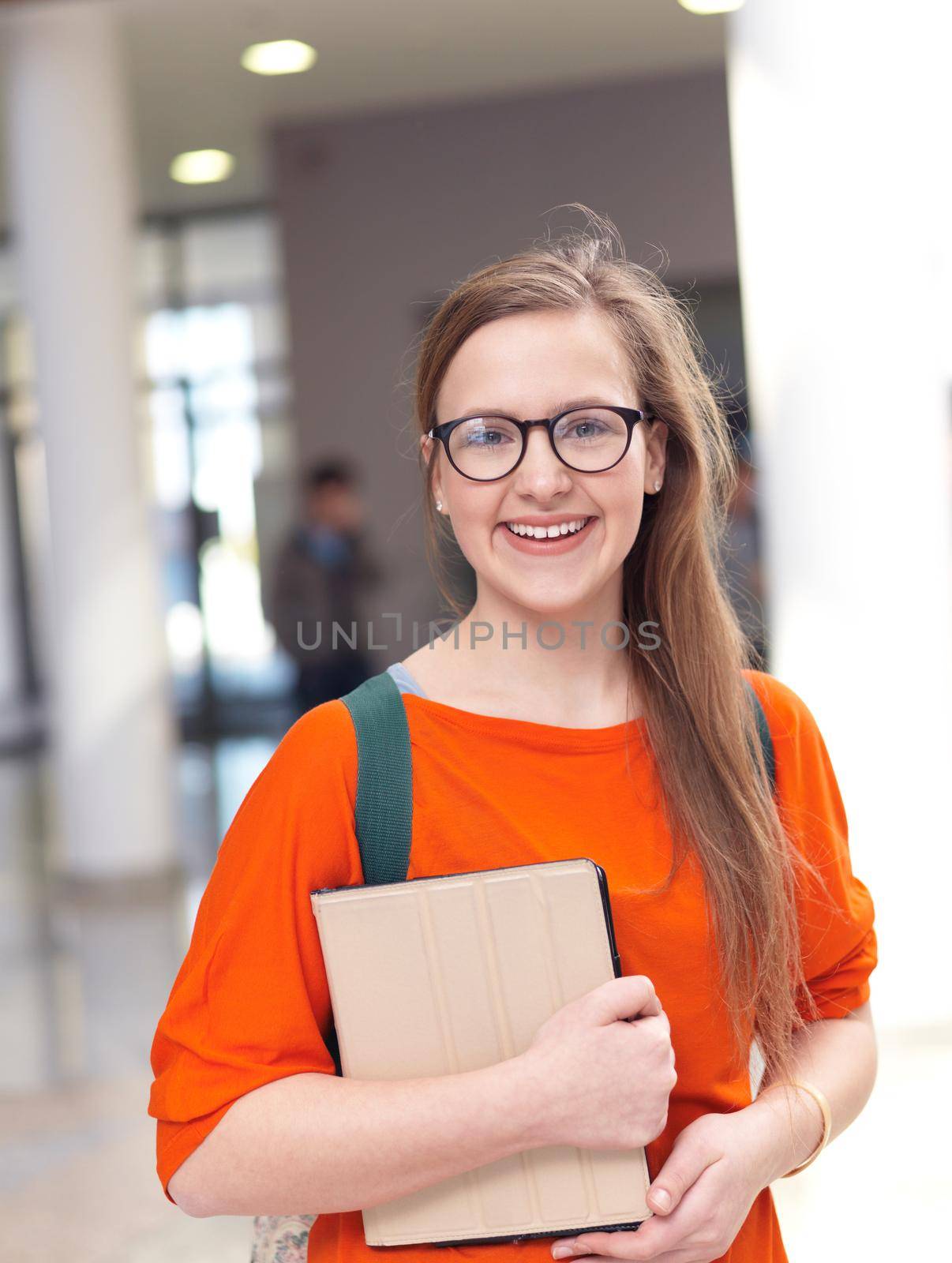 happy student girl working on tablet computer at modern school university indoors