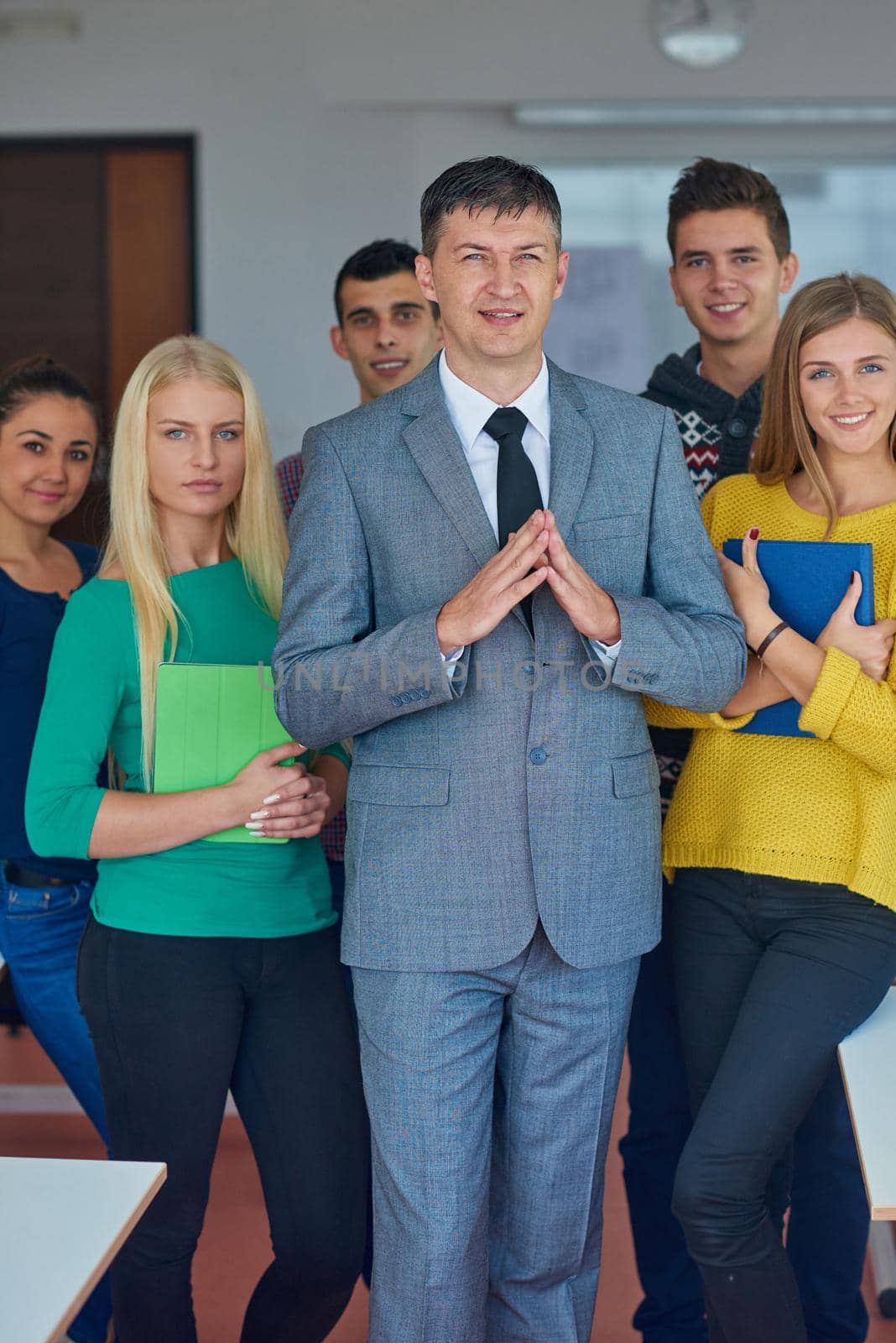 group portrait of teacher with students in shcool classrom