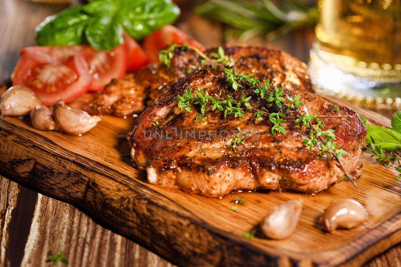  Fried pork steak on a wooden board  by Apolonia