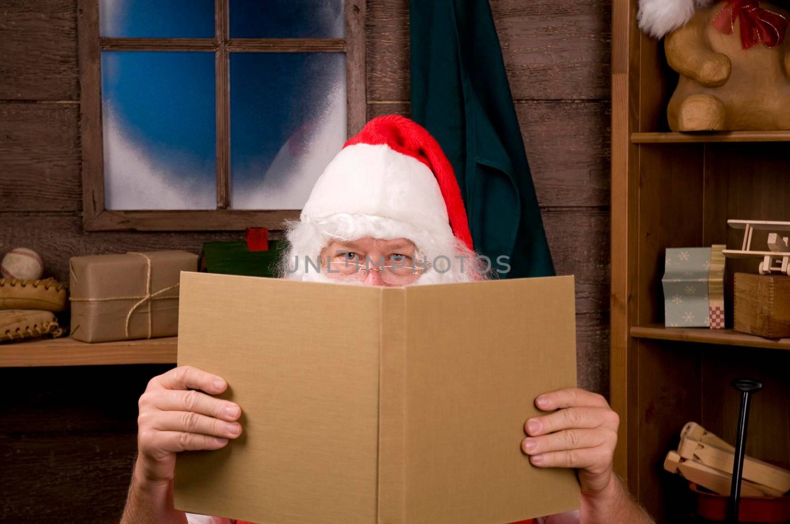 Santa Claus in Workshop With Large Book by sCukrov