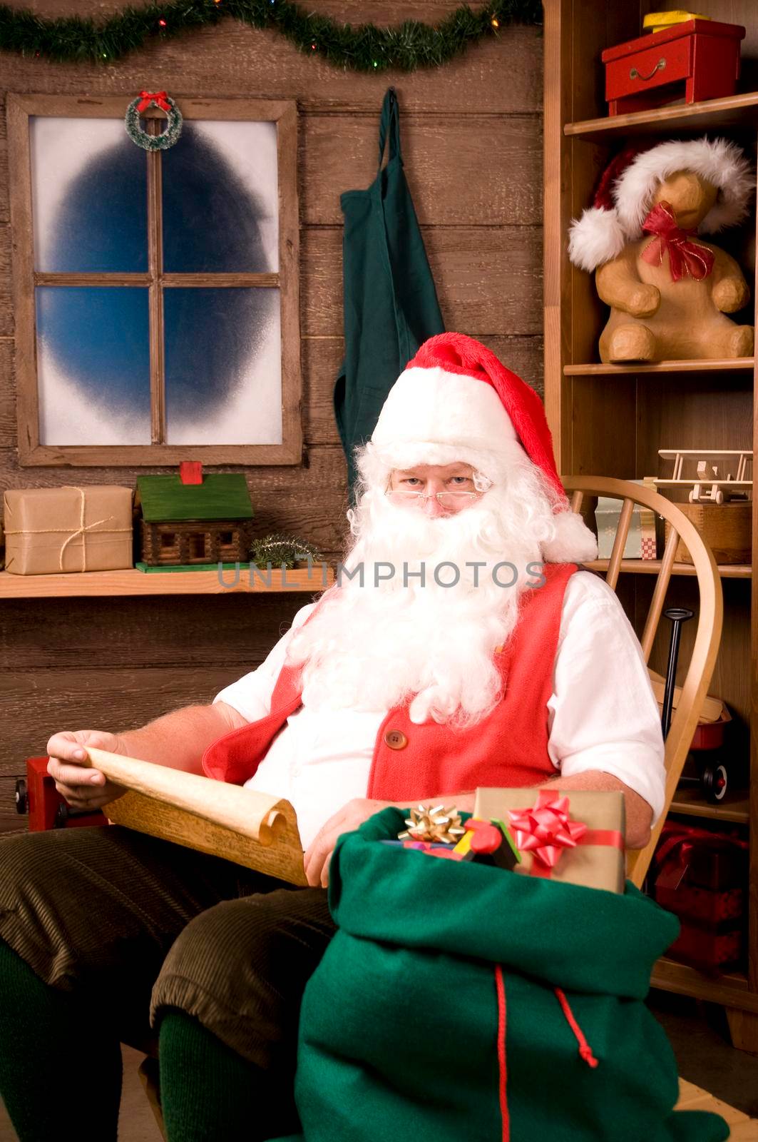 Santa Claus in Rocking Chair with Naughty List and Bag of Toys, vertical composition