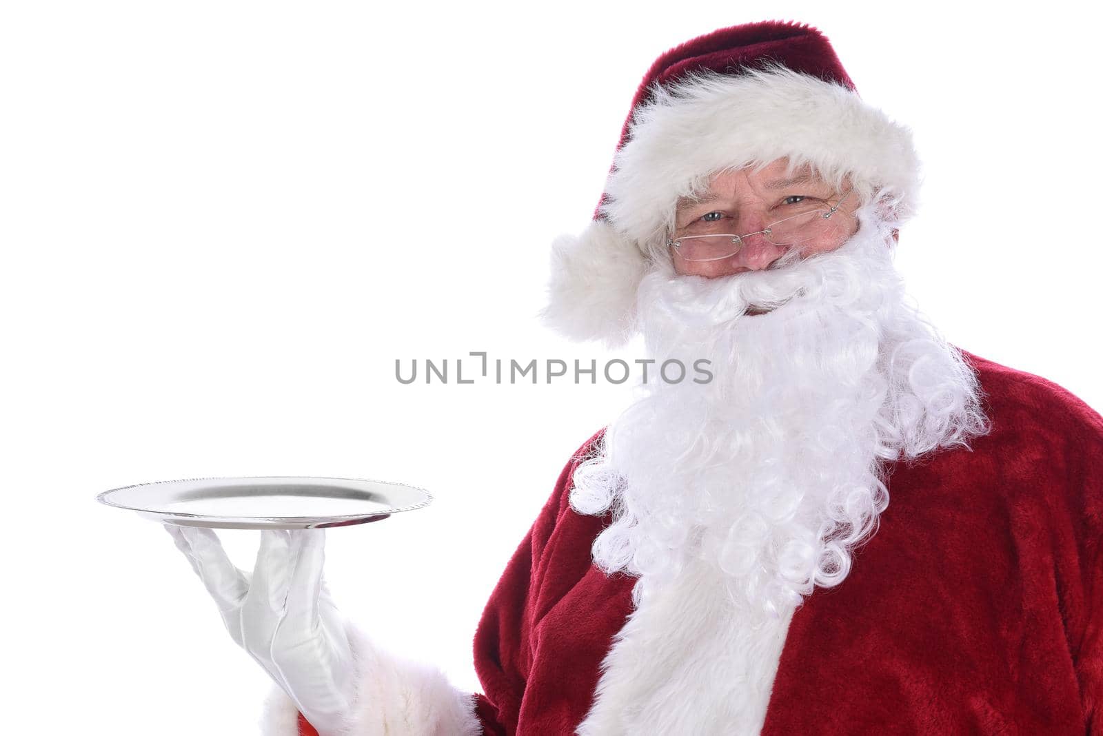 Santa Claus holding an empty silver platter isolated on white.