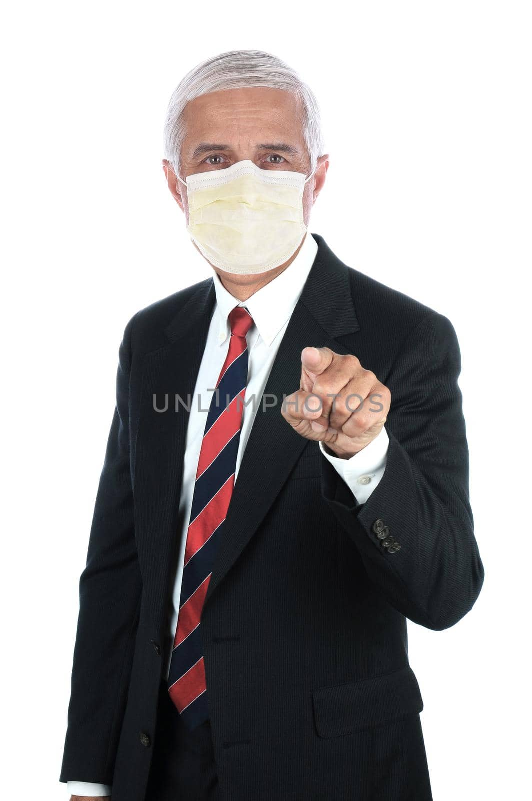 A middle aged businessman wearing covid-19 protective mask and  pointing at the viewer. Vertical format isolated on white.