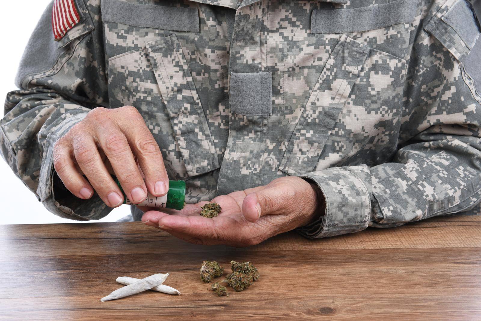 Military Drug abuse concept. Closeup of soldier with medical marijuana to treat his PTSD symptoms. by sCukrov