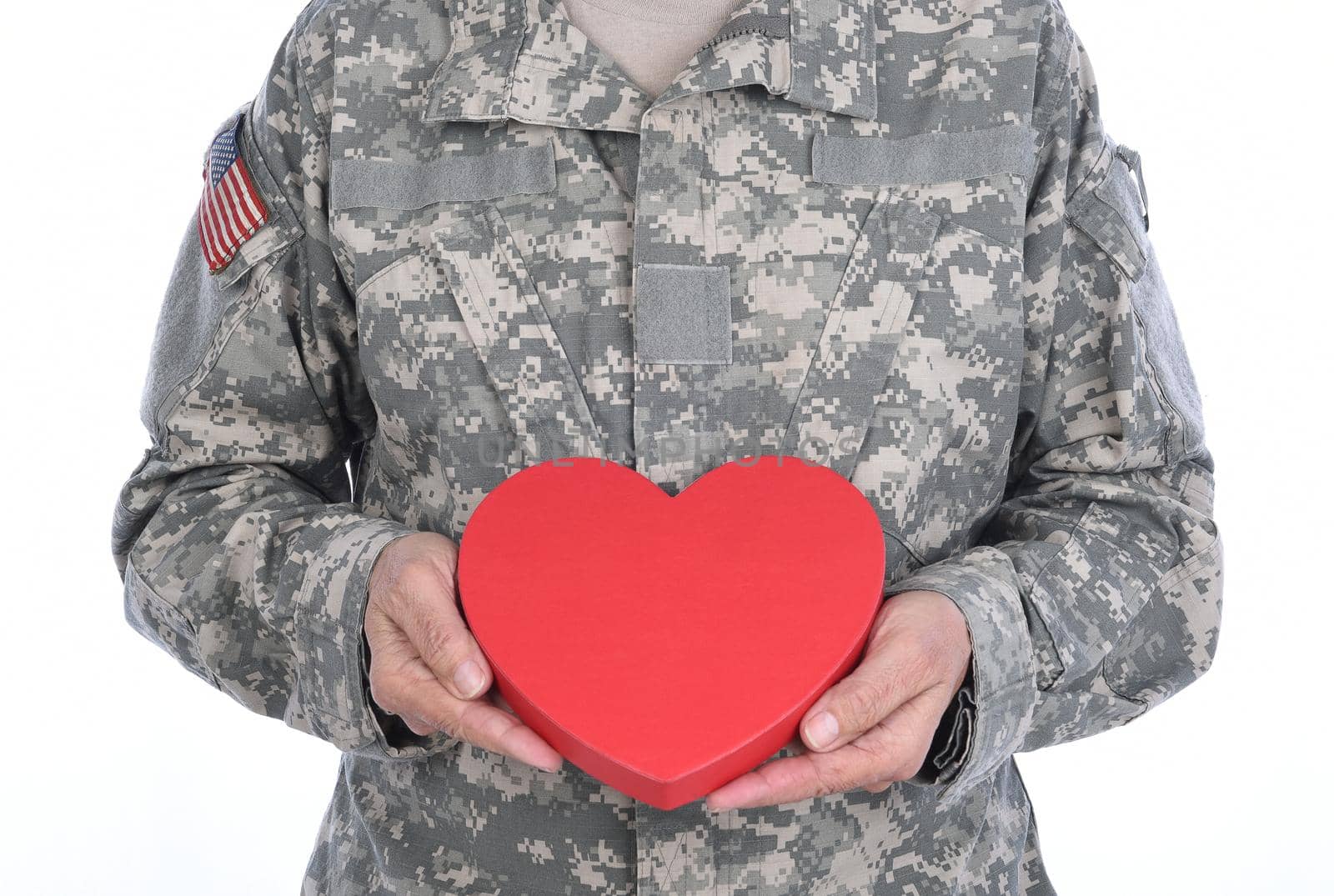 Closeup of a soldier holding a red Heart Shaped Valentines Day candy box. by sCukrov