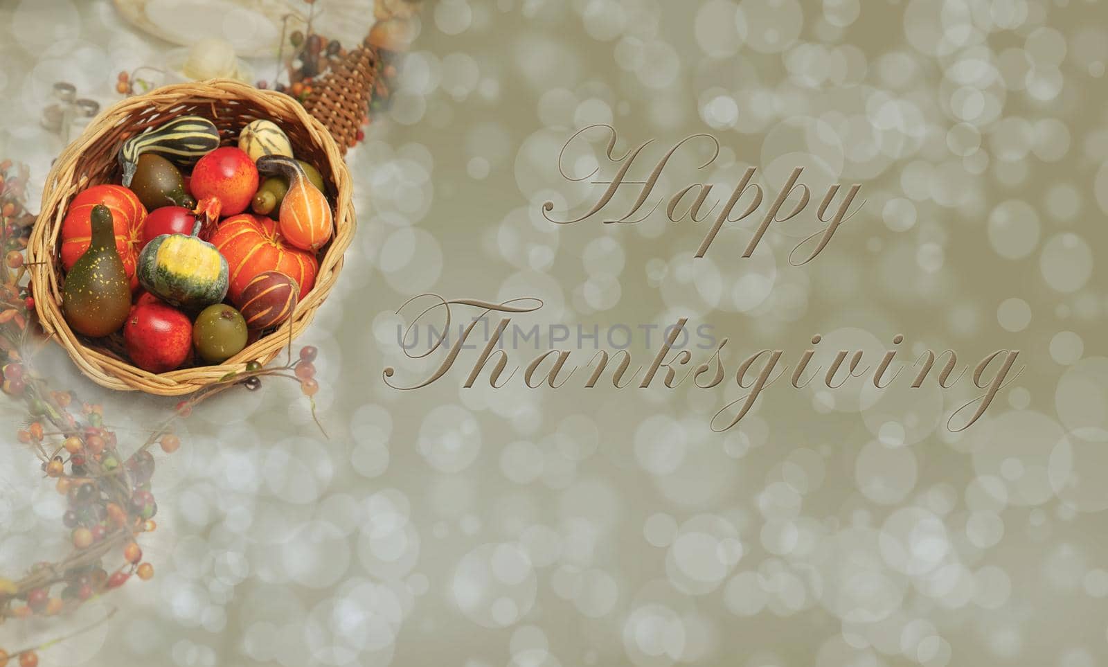Basket of gourds on a warm bokeh background with the words Happy Thanksgiving. Room for additional copy.