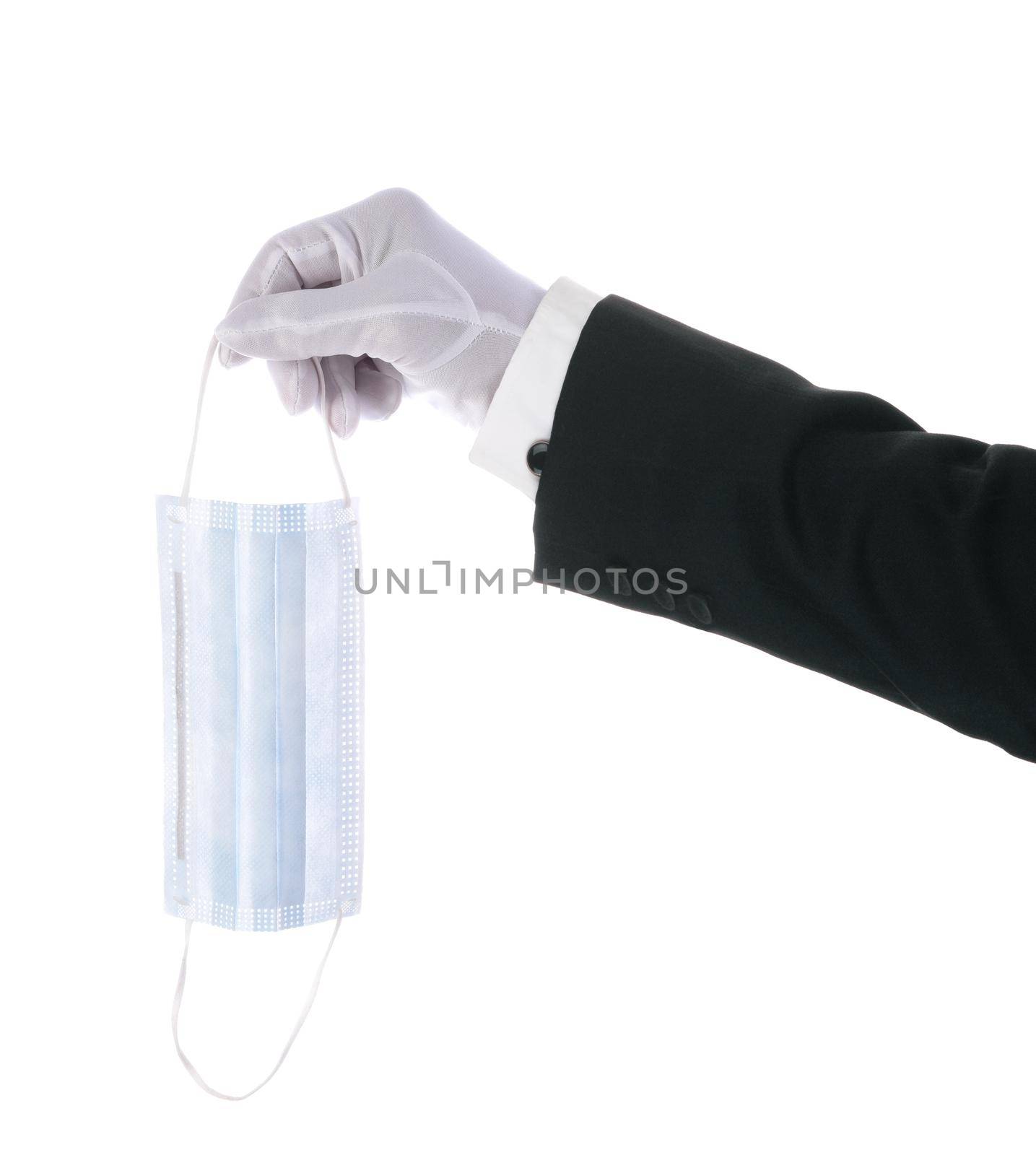 A  Tuxedo sleeve with a White Gloved hand holding a COVID-19 surgical mask over a white background. by sCukrov