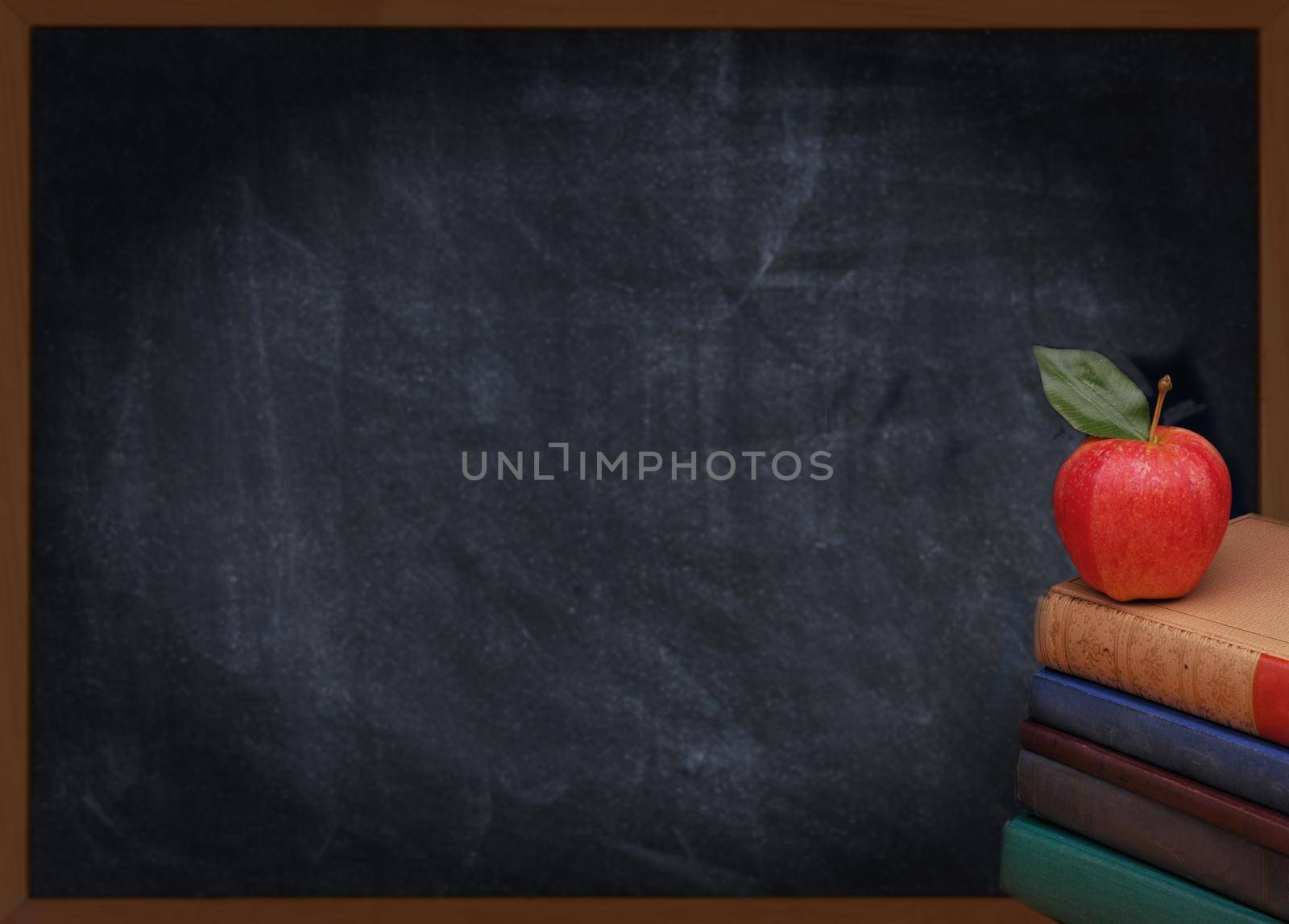A stack of books with a red apple on top in front of an out of focus chalkboard. Back to school or education concept. Vintage effect with vignette added. 