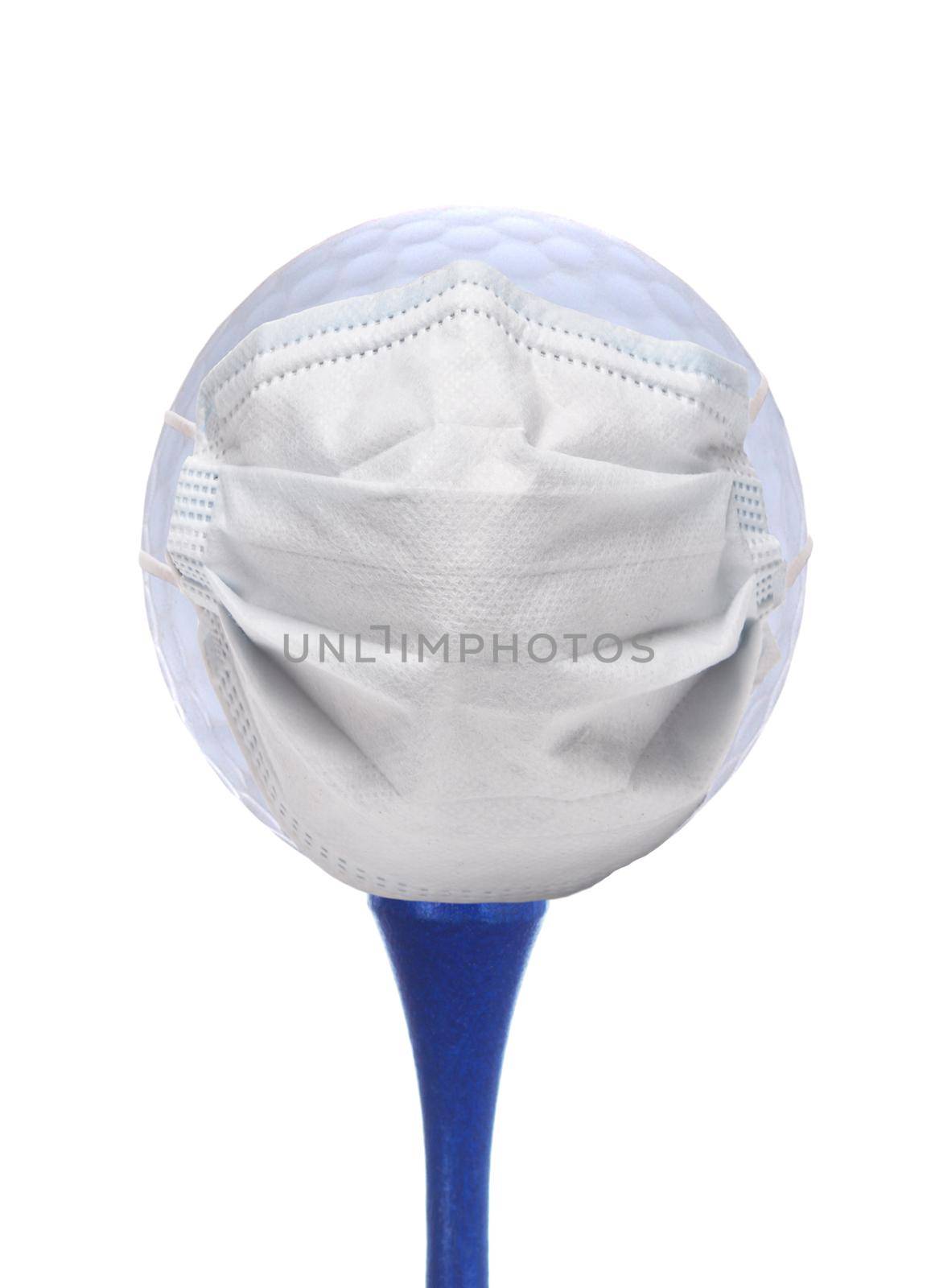 Sports and COVID-19 Concept- A Golf Ball with Surgical Mask on ablue tee isolated over white