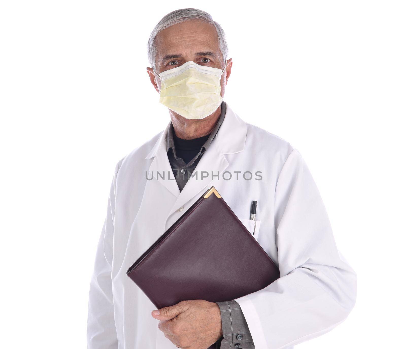 Portrait of a middle aged doctor wearing a surgical mask and lab coat holding a notebook under his arm. Isolated on white. by sCukrov