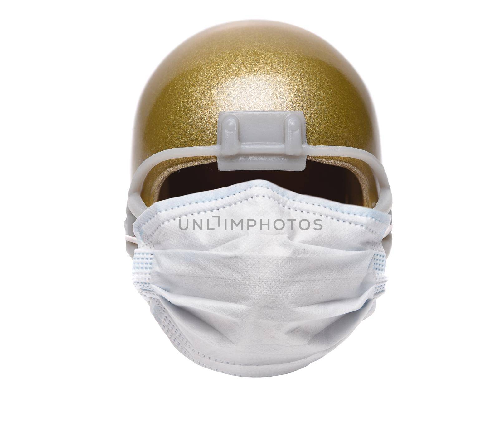 Sports and Covid-19 Concept.  An american Foortball Helmet with a surgical mask.  by sCukrov