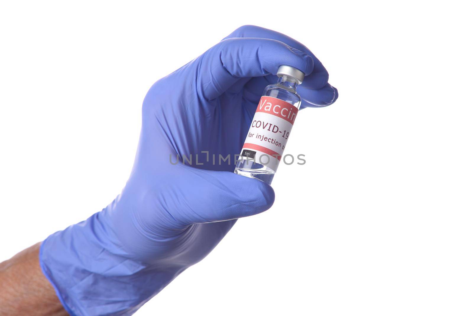 Close up of a hand in a blue latecx surgical glove holding a vial of Covid-19 Vaccine. by sCukrov