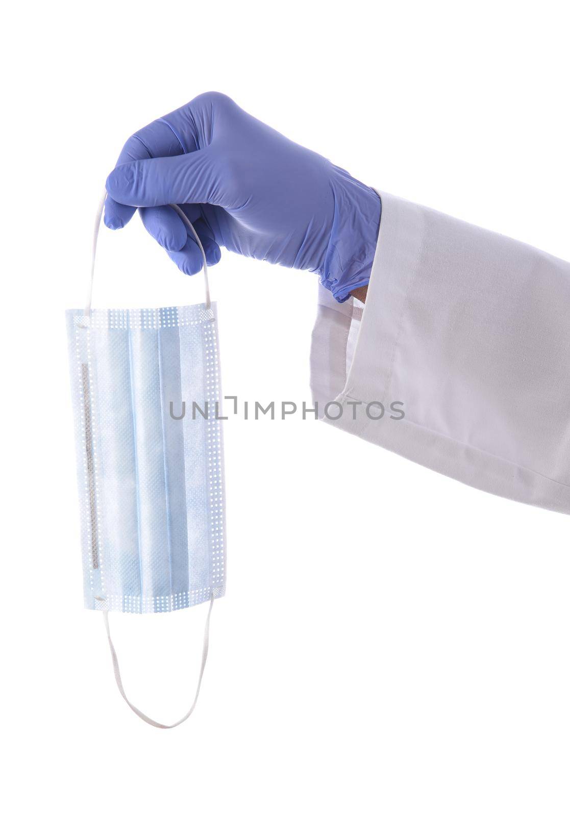 Closeup of a doctors hand and arm only holding a surgical mask, isolated on white. COVID-19 Concept.