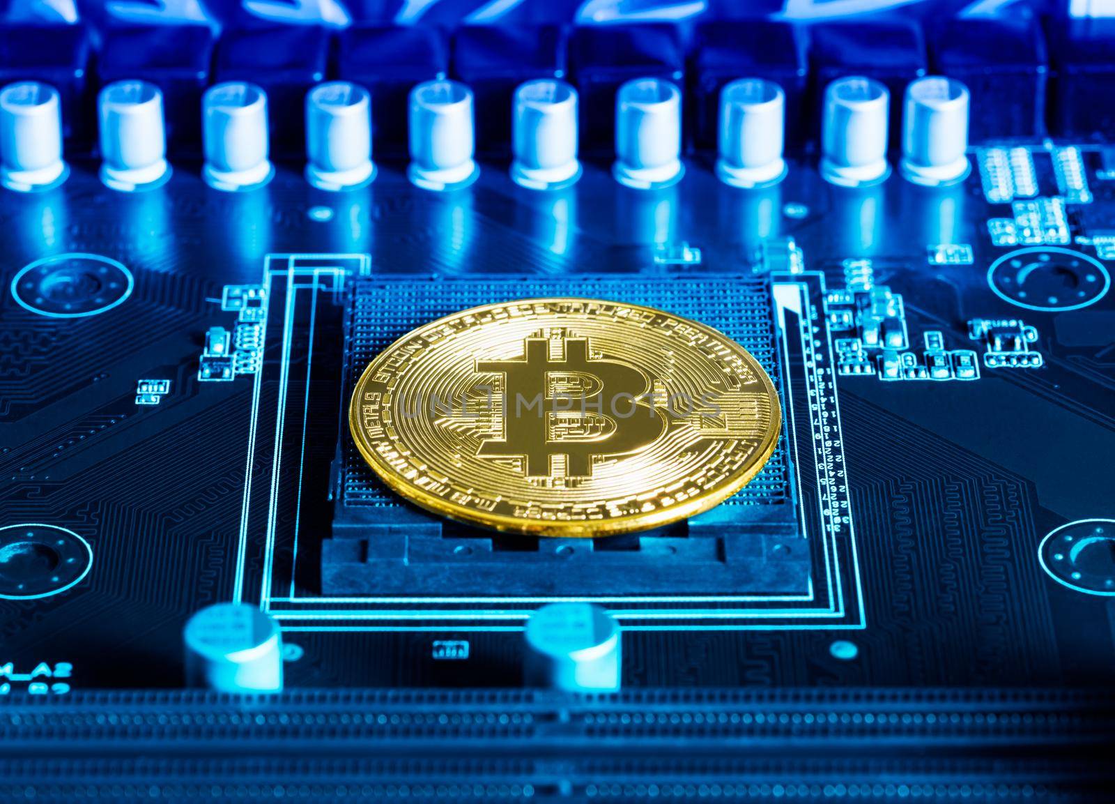 Cryptocurrency bitcoin coins on circuit board. Blockchain technology bitcoin mining concept