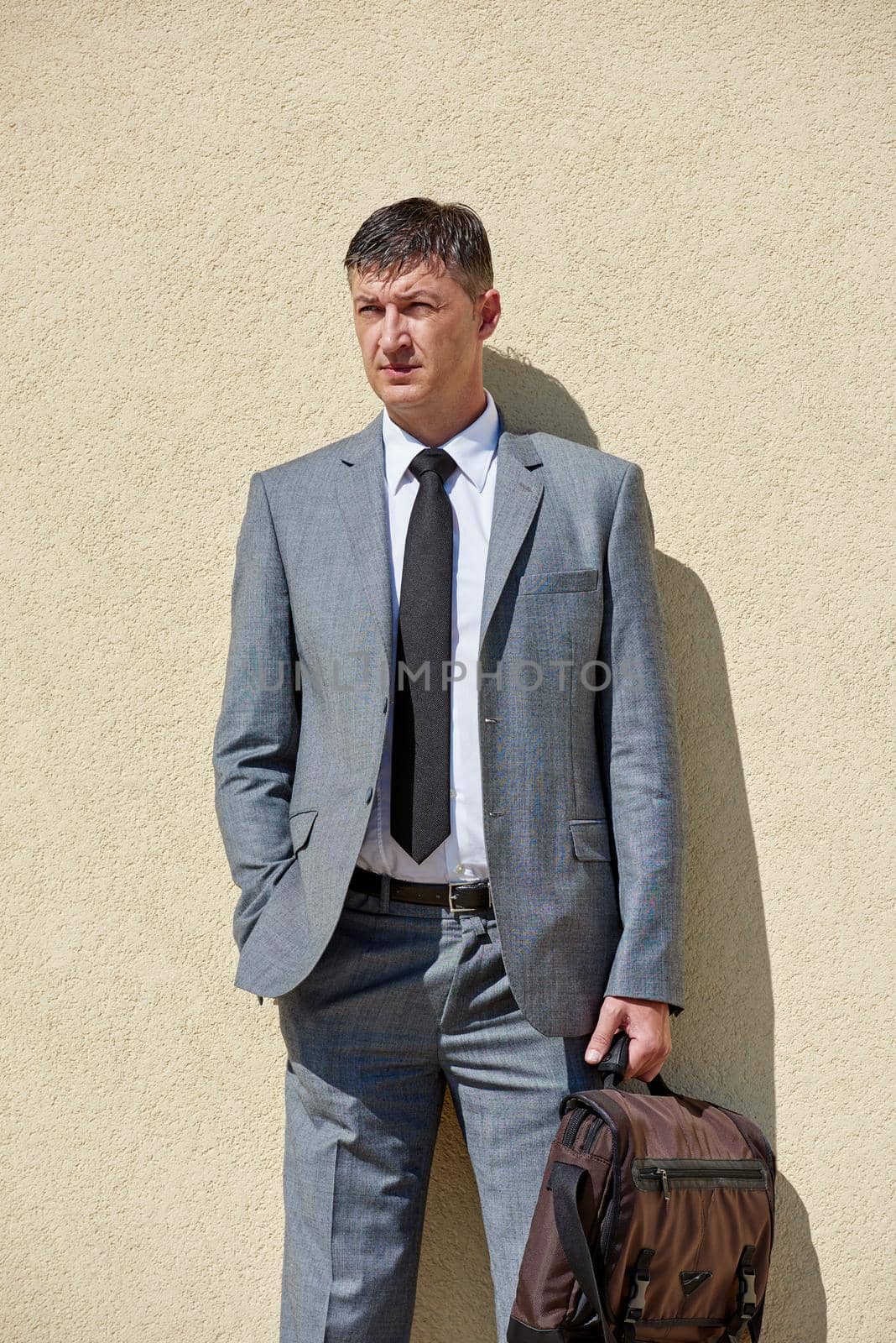 urban outdoor portrait of middle aged senior  business man