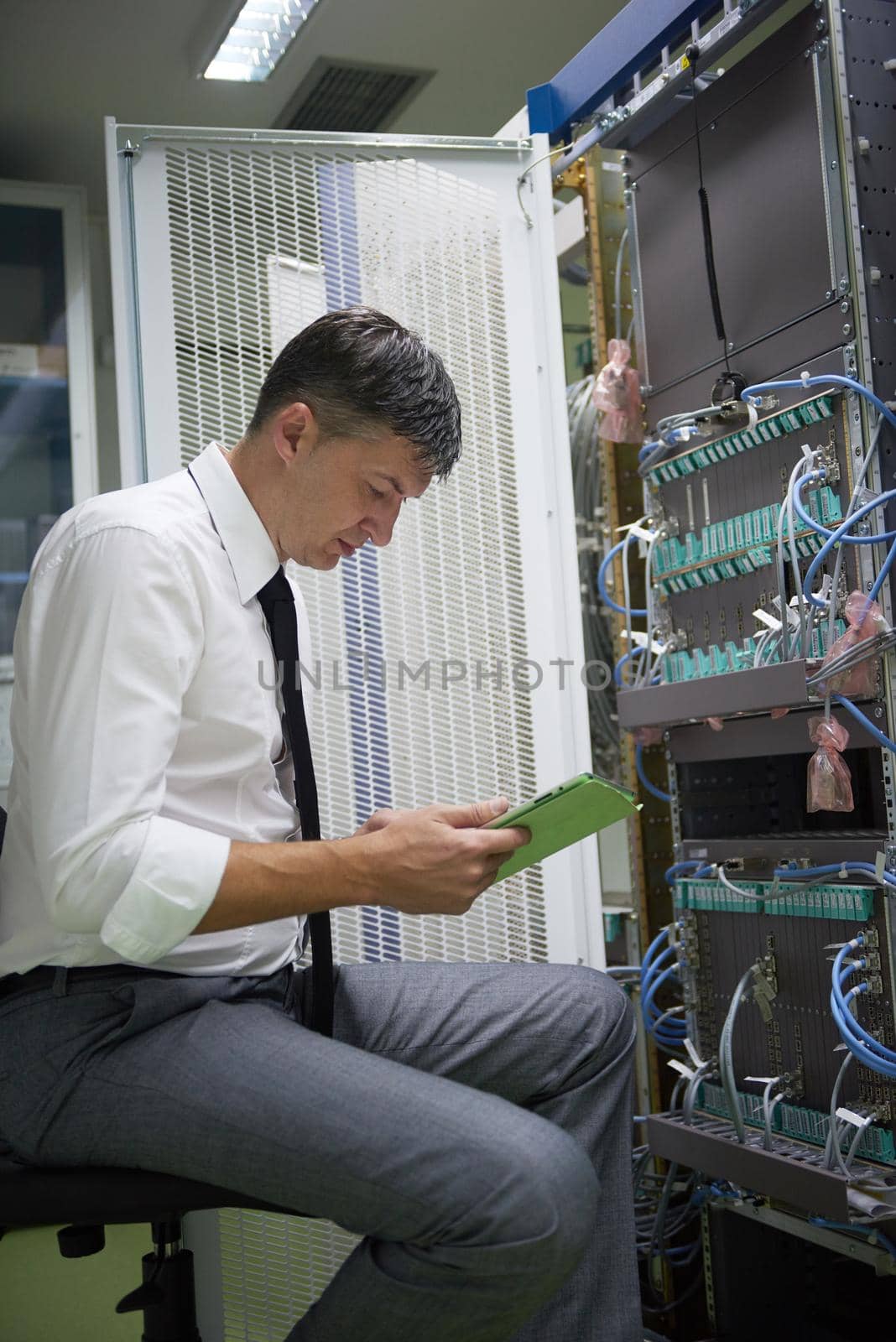 network engineer working in  server room, corporate business man working on tablet computer