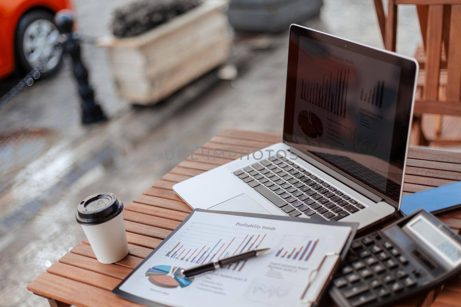 close up. laptop and financial chart on the cafe terrace. photo with a copy-space.