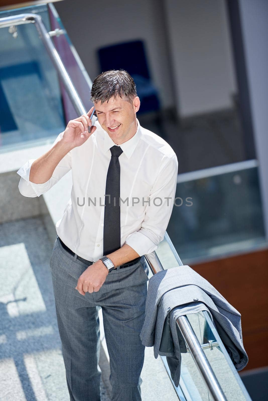 business man using phone at modern office space