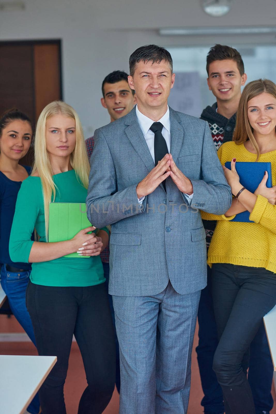 group portrait of teacher with students in shcool classrom