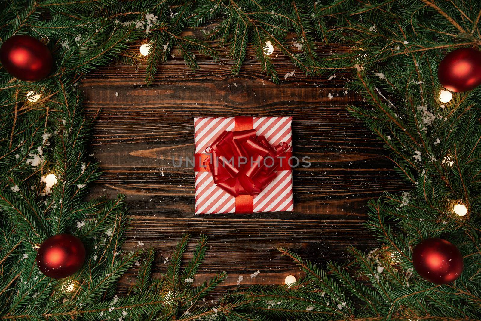 gift box and a Christmas garland on a wooden background . by SmartPhotoLab