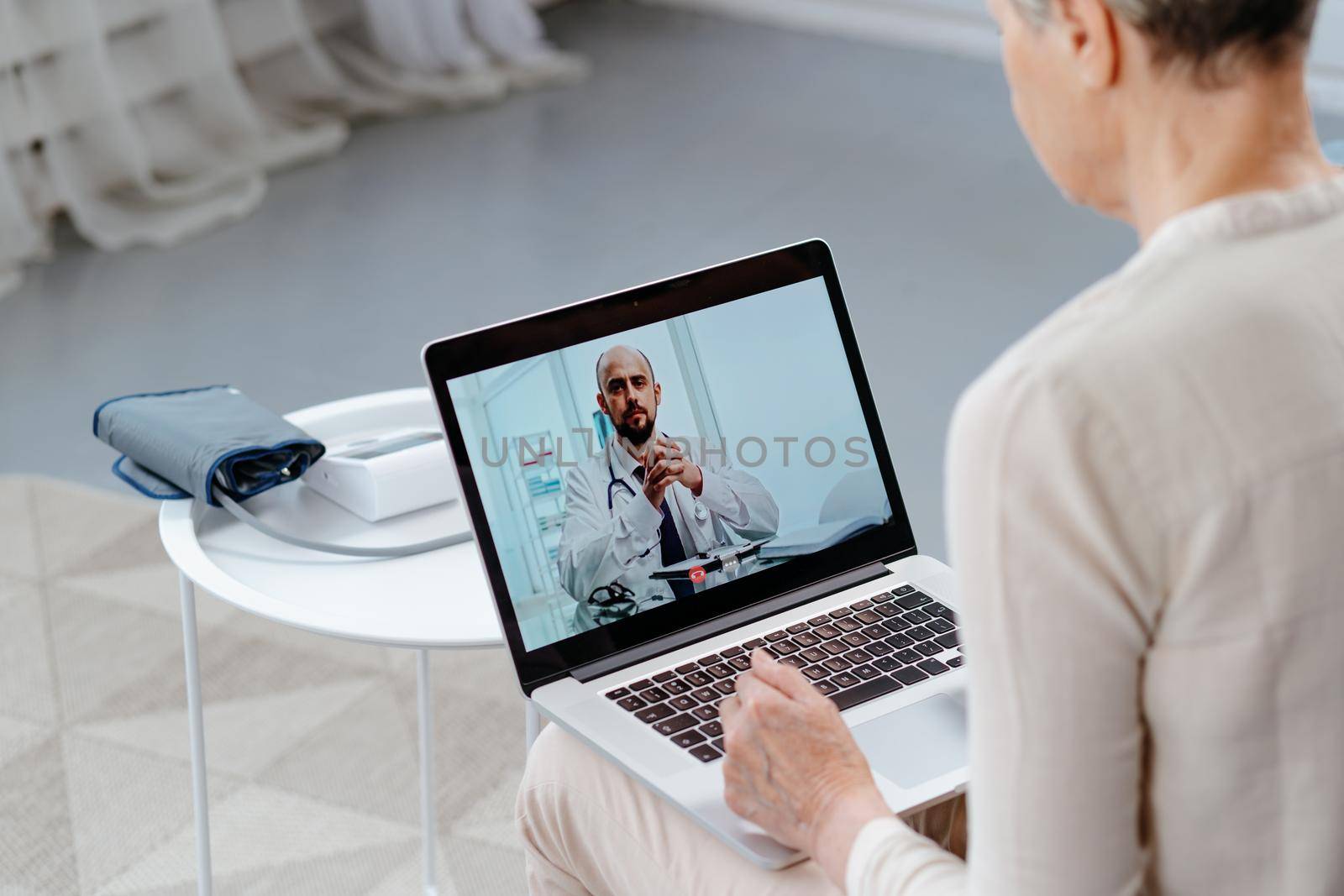 doctor talking to the patient via video link . by SmartPhotoLab