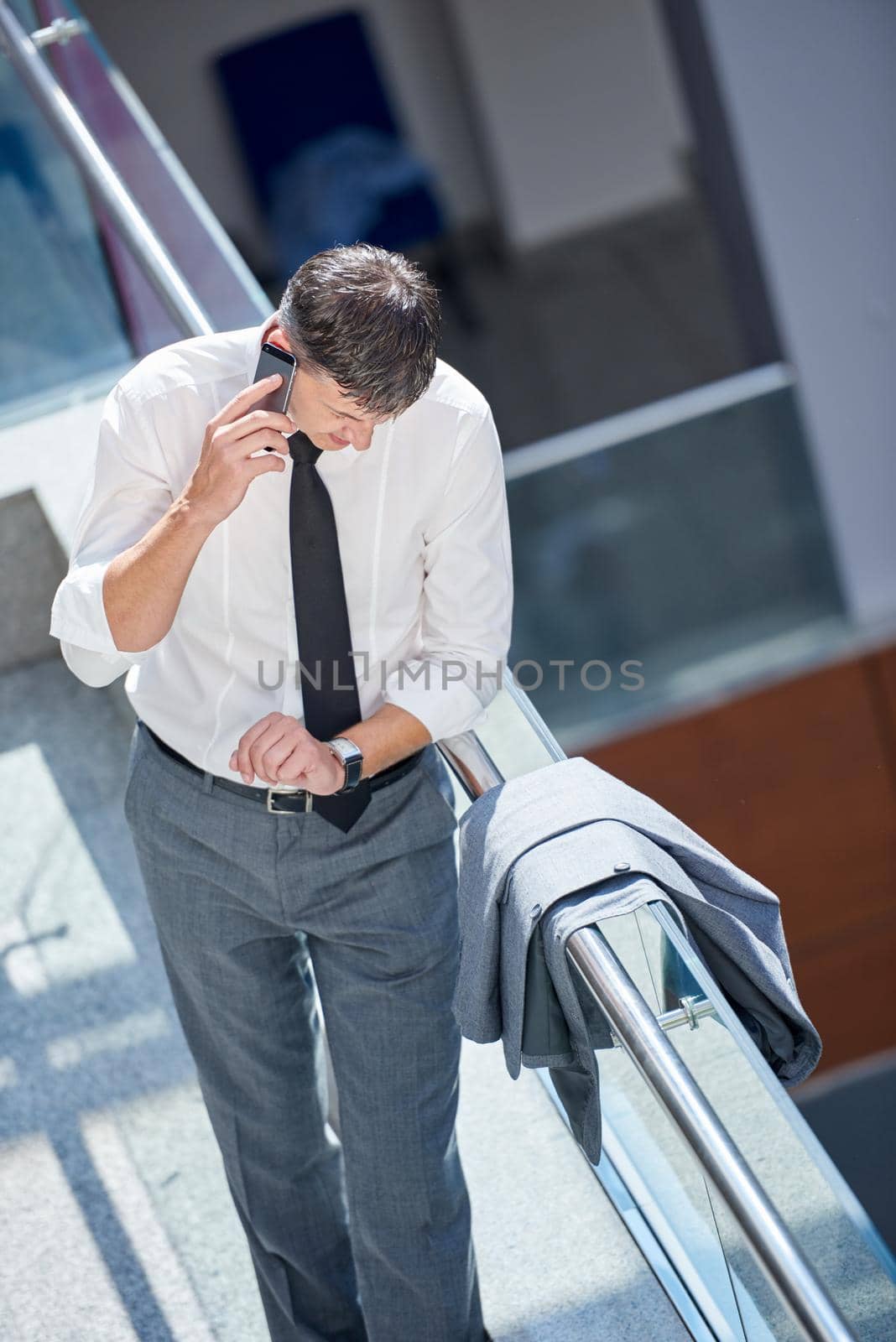 business man using phone at modern office space