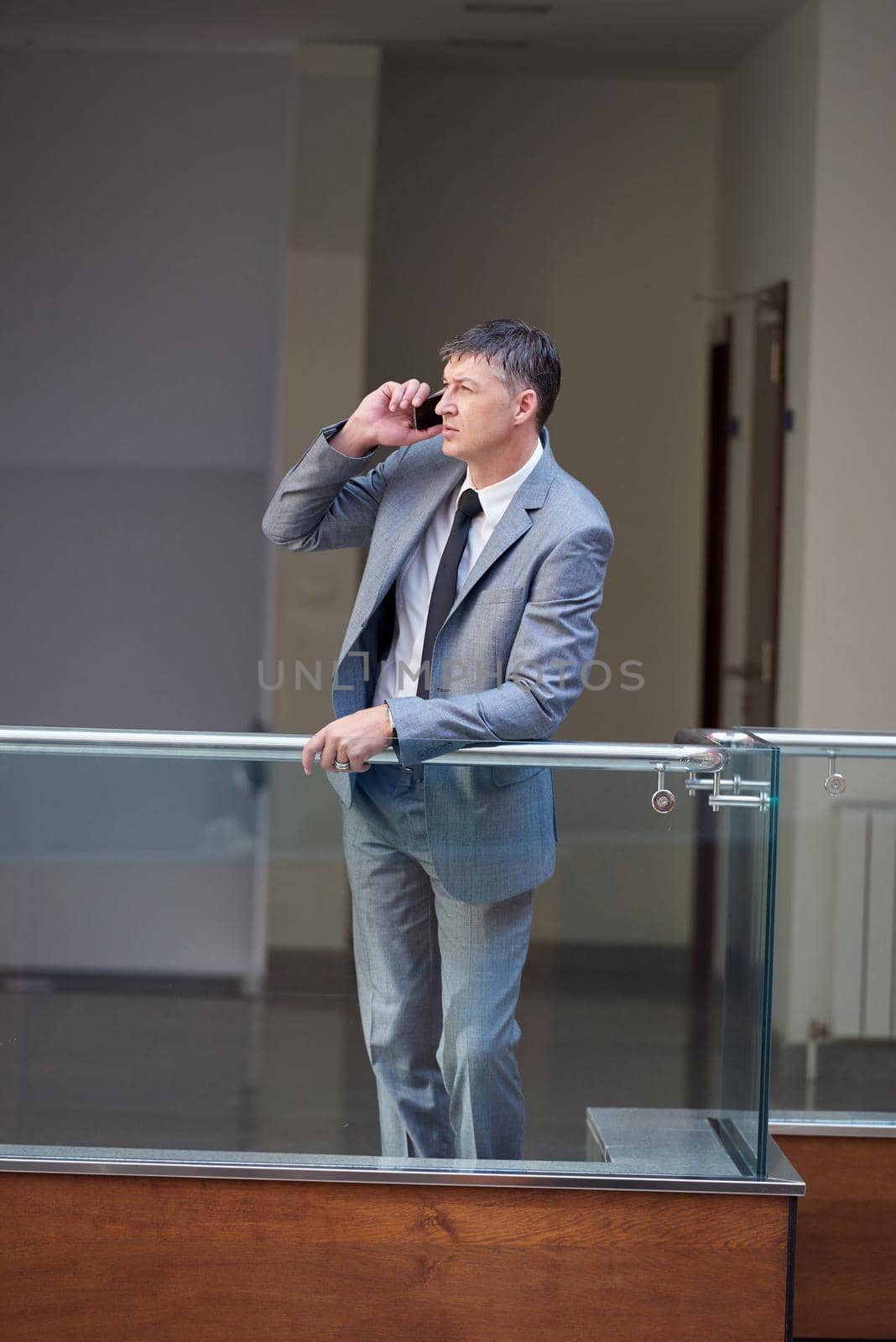 business man using phone at modern office space