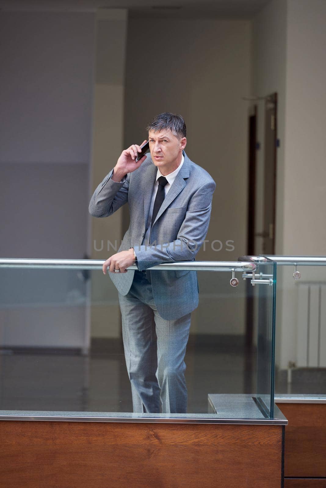 business man using phone at modern office space