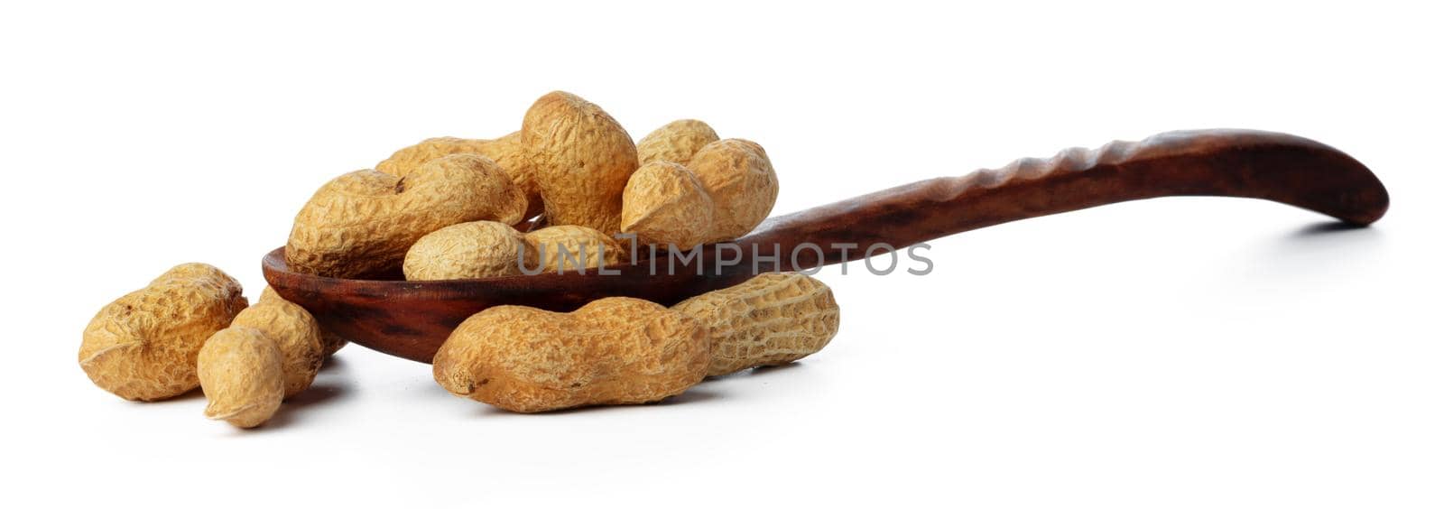 Spoon of peanuts in shell isolated on white background