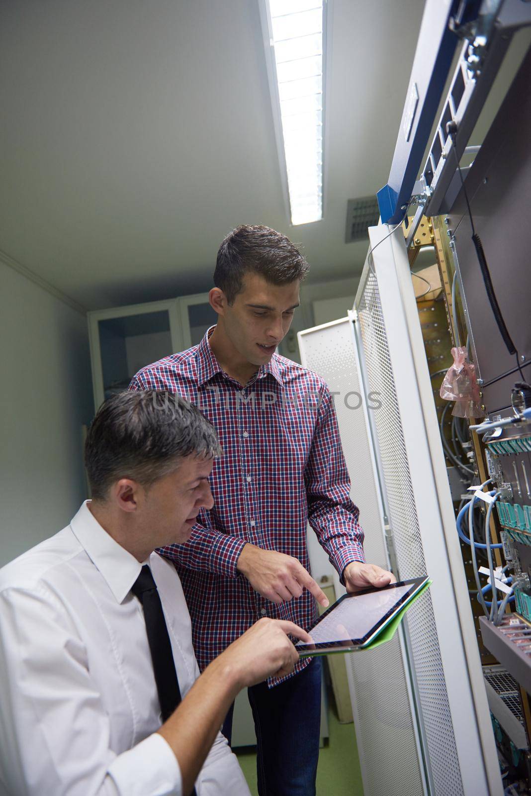 business people group working on tablet computer, network engineers in server room